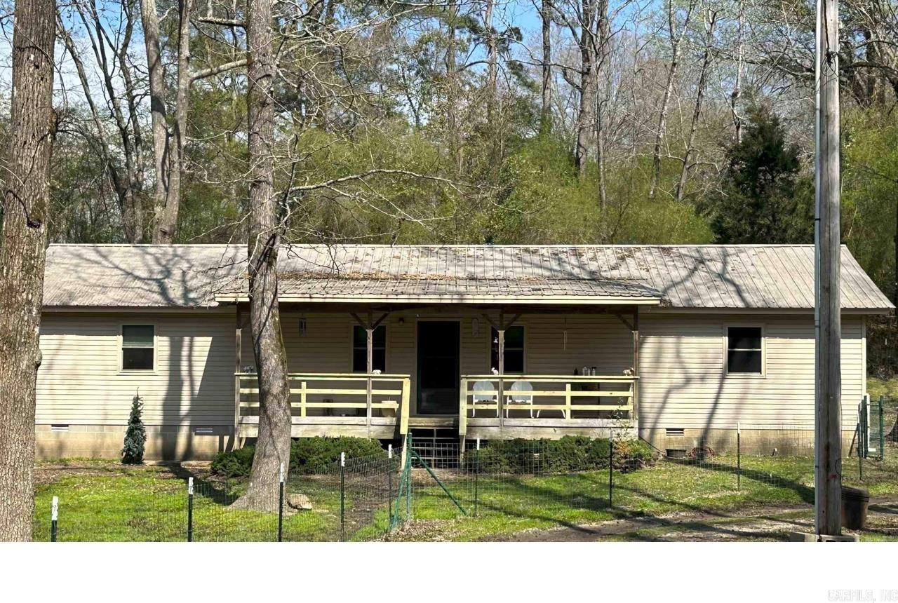 Tucked away on 7.48 beautiful acres within Malvern city limits, this 3 bedroom 2 bath home offers the privacy you've been searching for without sacrificing convenience. Surrounded by mature trees, this home is hidden from the road and neighboring properties, creating a peaceful retreat with a secluded driveway and plenty of room to roam. Inside, you'll find spacious bedrooms with generous closet space and a comfortable layout ready to make your own. If you've been dreaming of acreage, privacy, and location close to town, look no further!