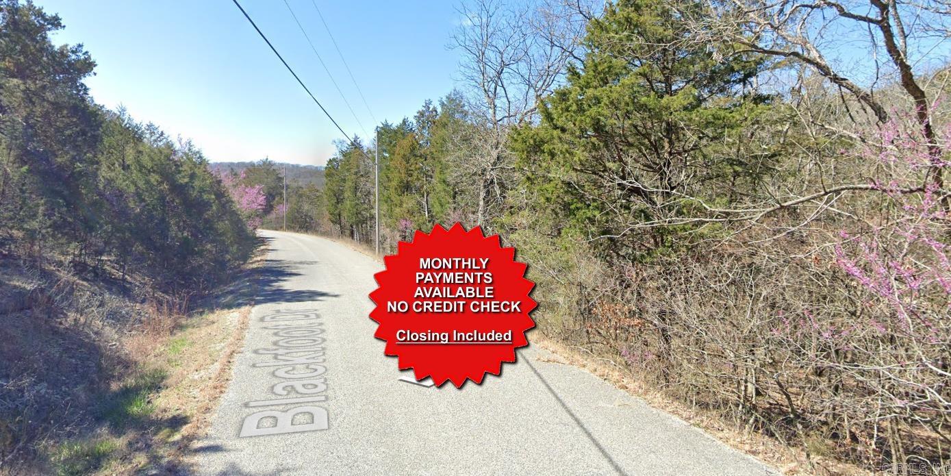 County appraised value $7500. Owner-finance available for easy terms. You cannot camp or park a trailer on the lot. No mobile homes but other types of housing is allowed. Not far from Eureka Springs, the Missouri and Oklahoma border and very scenic mountain area. Public sewer and water at the paved road and electric not far. Nice lot to develop or hold for future value. Owner/agent. Finance is $250 down and $295 a month for 10 months. Quit claim deed conveys. Closing costs are included. Bulk land sales specialist with the best land prices in Arkansas. Over 10 years, as a licensed Realtor, selling land.  Parcel ID# 320-03946-000