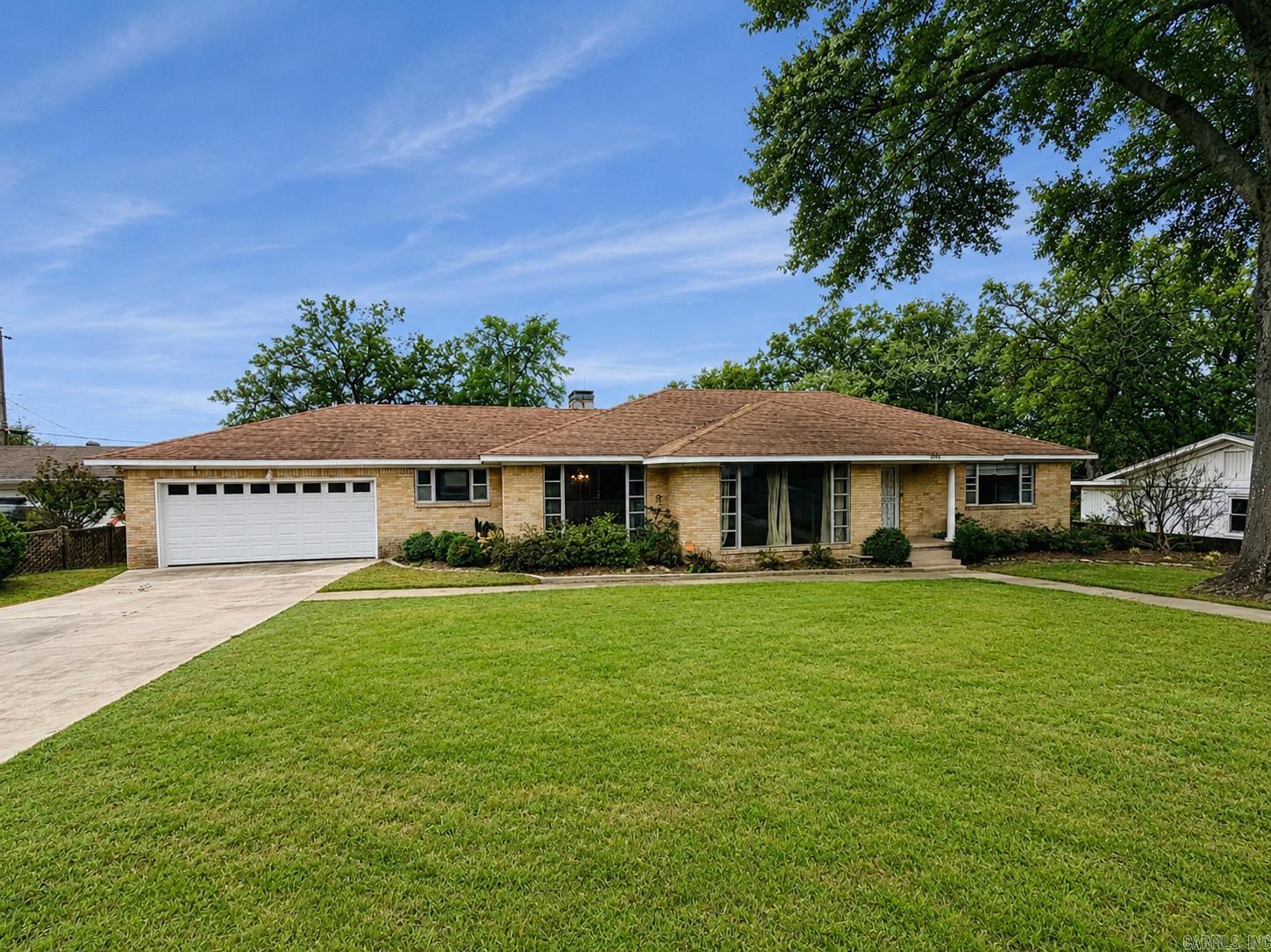 Charming all-brick, one-level home in the heart of Park Hill in a great location with easy access to I-40. This home features a fully fenced backyard, beautiful hardwood floors throughout most of the home, and two open living areas.  There is a formal dining space and an eat-in kitchen. The updated kitchen offers a chef’s 6-burner gas range, stainless dishwasher and microwave and granite countertops. The primary bathroom has also been updated with a walk-in shower. One of the living areas includes a gas-log fireplace. Outside, enjoy a private backyard with a large deck and views of downtown Little Rock and the Arkansas State Capitol. AC was replaced in 2022.  There is a 2-car garage with extra storage.  Refrigerator, washer and dryer convey. Agents See Remarks.