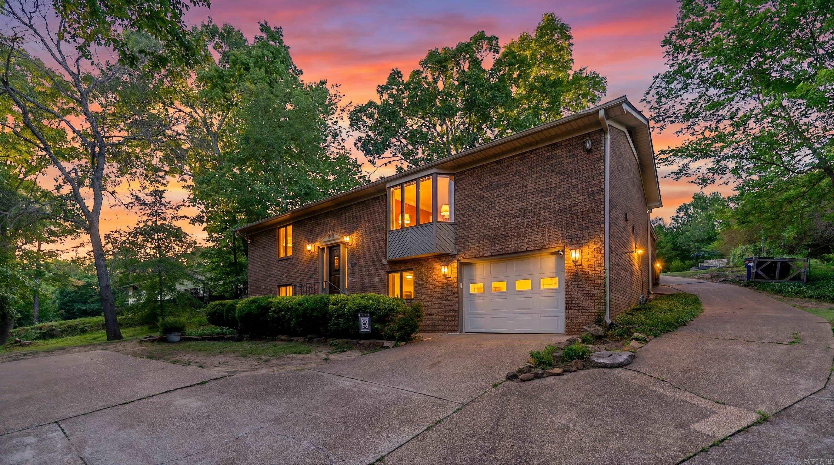 Spacious Brick Home in Town | Batesville, Arkansas  Updated 5-bedroom, 3-bath home in Batesville with approximately 2,950 square feet of living space and numerous recent improvements. Interior features include fresh paint, modern lighting, updated electrical, and a Bluetooth sound system throughout the home. The kitchen offers updated cabinets, granite countertops, new appliances, and a double eatery area. Spacious bedrooms provide flexibility for family, guests, or office space, while all three bathrooms have been well maintained. The updated sunroom includes new flooring, paint, trim, and abundant windows for natural light. Outside, enjoy a freshly stained back deck overlooking a large backyard with mature trees, ideal for entertaining. Additional features include a new French drain, one-car garage, and a heat and air system only three years old. Conveniently located near the White River and local amenities.