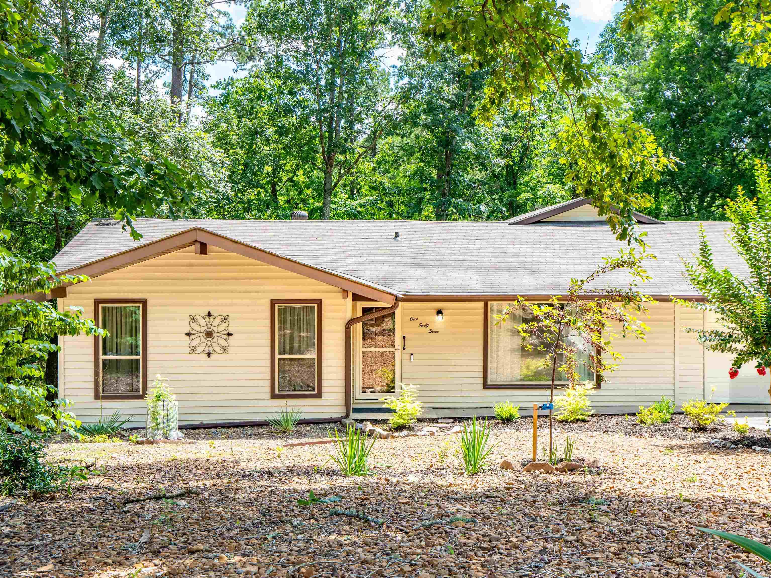 Move in ready home situated amidst the trees! This tranquil home, nestled within Hot Springs Village is close to trails, lakes, golf courses, pickleball and many other amenities, it combines comfort with simplicity. Expect to find an updated interior with cleverly designed spaces to maximize utility. A fully equipped kitchen, cozy living room and peaceful bedrooms make it an ideal place for anyone looking for quietude. The expansive windows enhance the indoor-outdoor connection. Enjoy a cup of coffee viewing nature on the deck. Features that make this home stand apart: beautiful kitchen, new 2025 HVAC system, Arkansas room, luxury vinyl plank flooring throughout, updated and ready for you to unpack your bags. Hot Springs Village has a one time new owner buy in fee of $2000. Don't miss this opportunity to buy your slice of paradise!