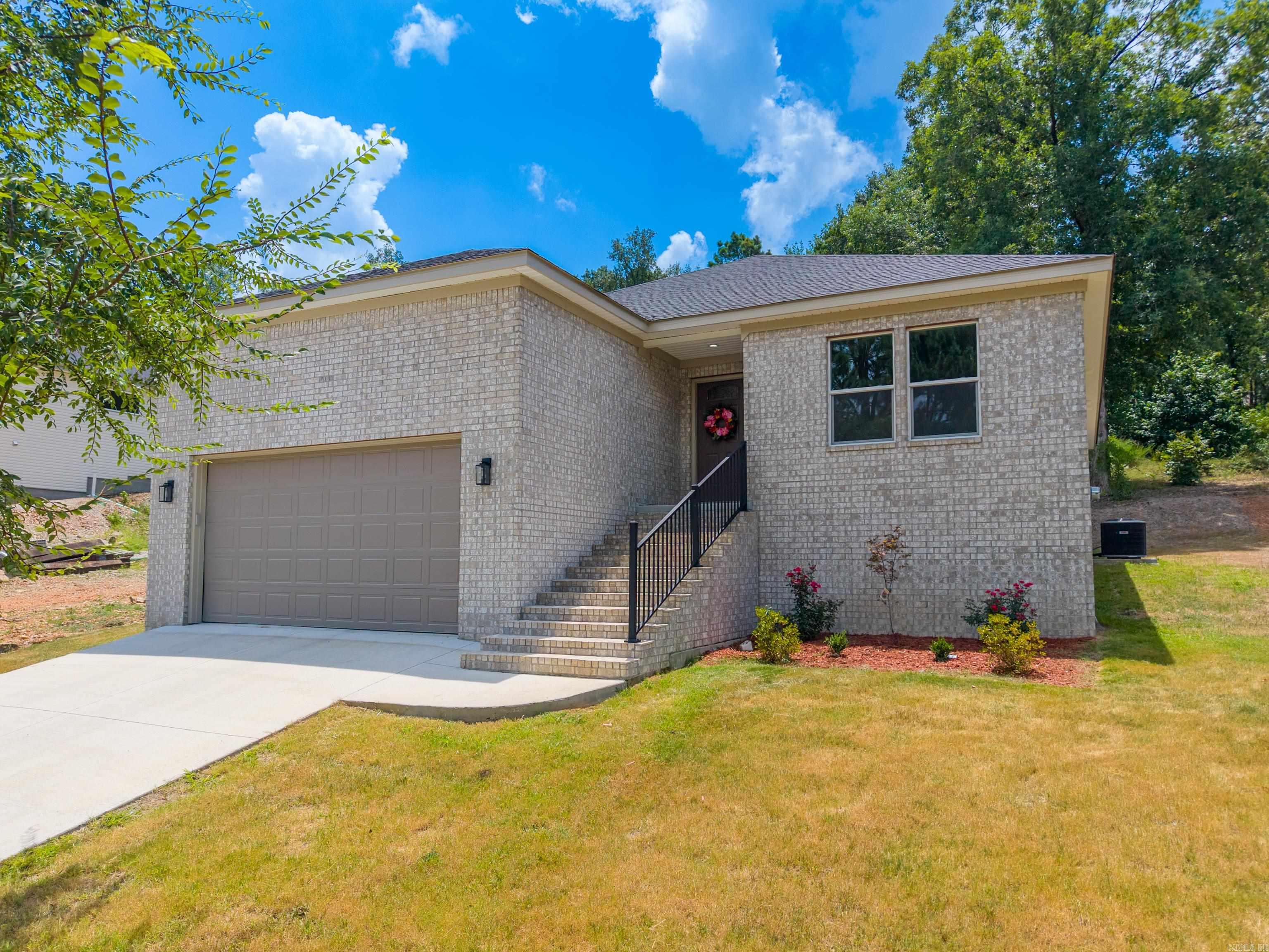 Experience the ease of brand-new construction with the added freedom of no HOA, all in a convenient central Hot Springs location. Just minutes from Oaklawn, the bypass, shopping, restaurants, and every Hot Springs school district, this thoughtfully designed home offers the perfect blend of style, comfort, and functionality.  The well-planned floor plan features 3 bedrooms, 2 bathrooms, and an oversized garage with plenty of room for vehicles and storages. At the heart of the home, the spacious kitchen is designed for everyday living and entertaining, offering abundant cabinetry, generous workspace, and an open flow into the main living area. You'll appreciate the exceptional storage throughout the home—a rare feature in new construction at this price point.  Whether you're purchasing your first home, downsizing, or simply looking for low-maintenance, modern living in a prime location, get ready to call this house a home.