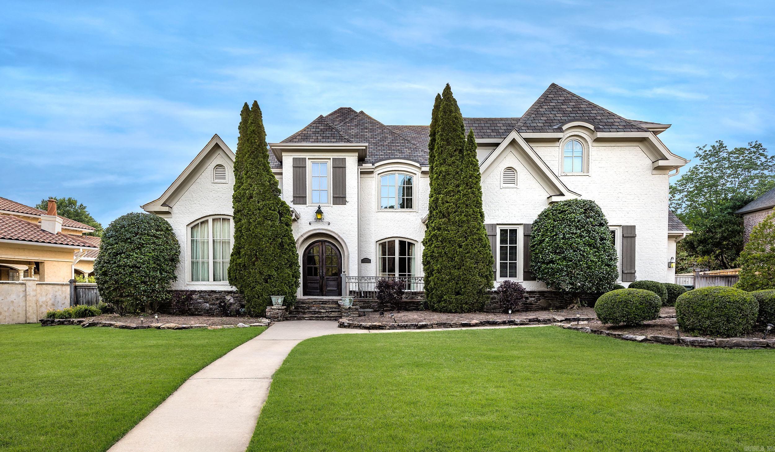 Stunning luxury home located in the prestigious gated Chenal Valley Deauville community. Situated on a beautifully landscaped 0.45-acre lot, this exceptional 5-bedroom, 4 full bath, and 2 half bath residence offers approximately 5969 square feet of elegant living space designed for both entertaining and everyday comfort. The spacious floor plan features a grand entry, soaring ceilings, abundant natural light, formal dining room, private office/study, game room, media/theater room, and multiple gathering spaces throughout. The luxurious main-level primary suite provides a peaceful retreat with a spa-like bath and generous space. The gourmet kitchen is equipped with double ovens, gas range, large island, breakfast bar, pantry, and extensive cabinetry, opening seamlessly into the inviting living areas with fireplaces and custom details throughout. Additional highlights include hardwood and tile flooring, wet bar, sprinkler system, covered porch, fully fenced backyard, and side-entry three-car garage. Enjoy upscale neighborhood amenities including gated access, pool, and playground. Experience luxury, comfort, and timeless style—schedule your private showing today!