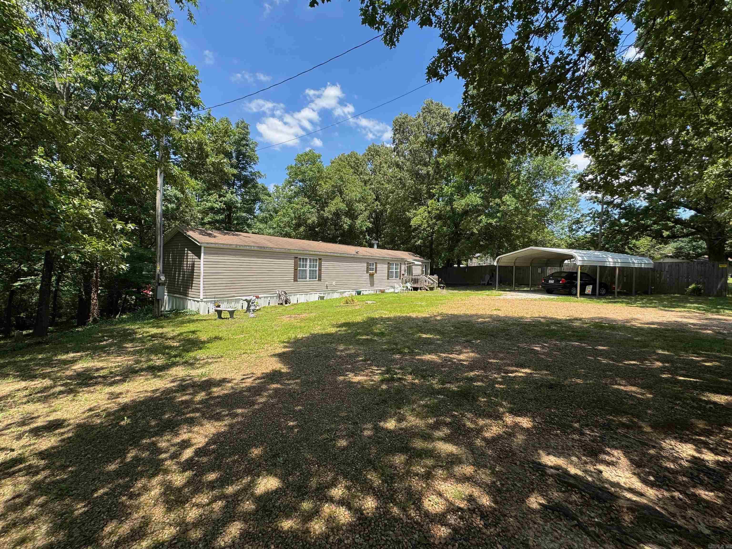 2 bed 2 bath Country home on an acre in Westside School district with beautiful master suite featuring a soaking tub, walk-in shower, dual vanities, and a spacious closet. The open floor plan living area has a fireplace, breakfast bar, and sliding glass doors leading out to a deck with two levels. There are two storage buildings in the shaded backyard. Refrigerator will remain with the home.