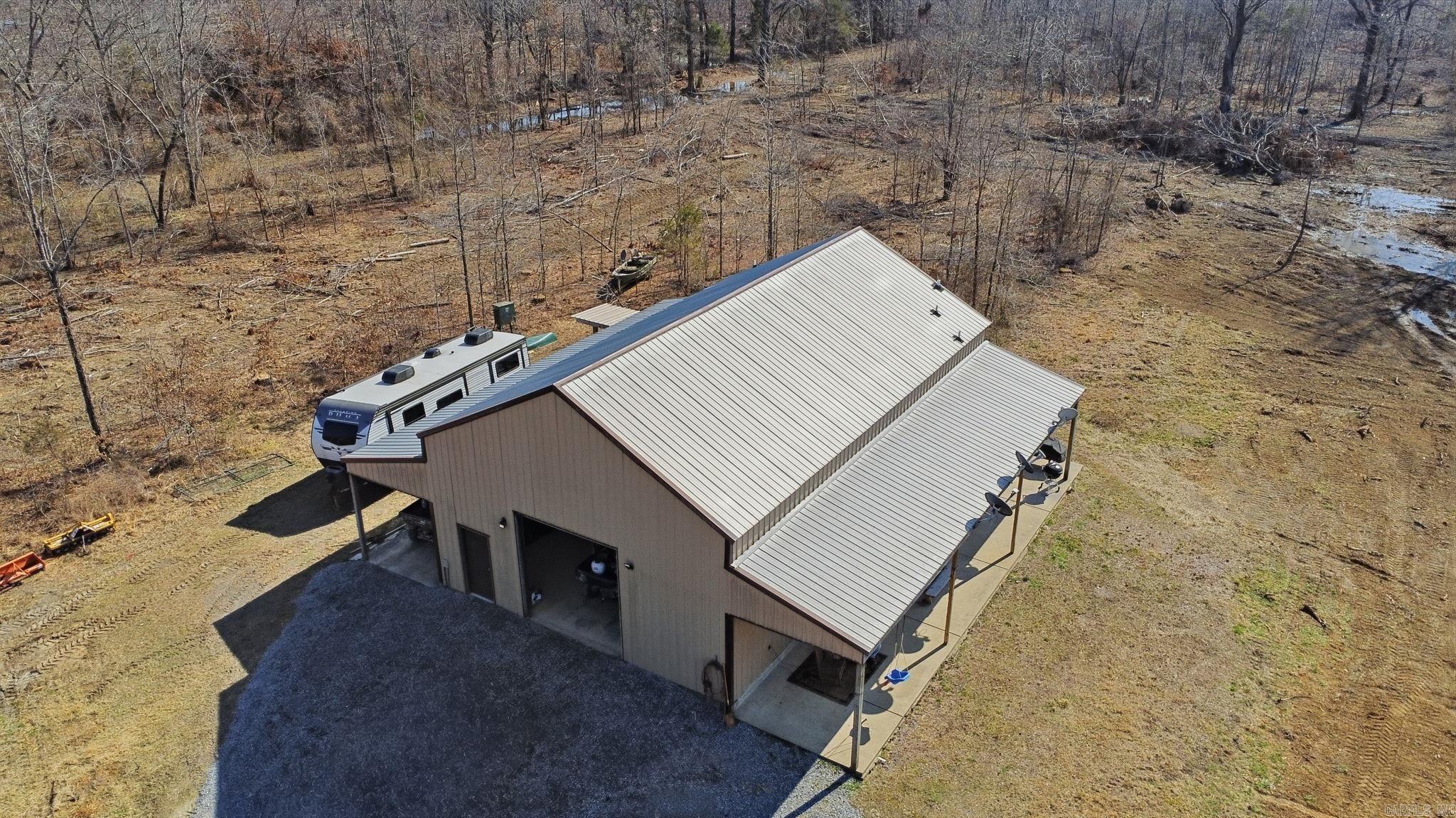 1003 Wildwood Cove has it all! 30X50 Barndominium with Enclosed Garage and easy to access Upstairs (Unfinished), 183.14 acres of proven Hunting Property, Riverfront Access, 3 Ponds, and an established House Pad to build your Dream Home! The Barndominium offers a Studio-Style Living Space, finished Bathroom with Walk-in Shower, and Spacious Kitchen with Kitchen Island. Easy to maintain Concrete Flooring in Living Area, as well as LVP Flooring in Kitchen Space. The Barndominium is completed with 10 Ft. Covered Porch Awnings offering Beautiful Views of the Property. Peaceful and Quiet, 1003 Wildwood Cove is the Ultimate Oasis and Ideal Investment.