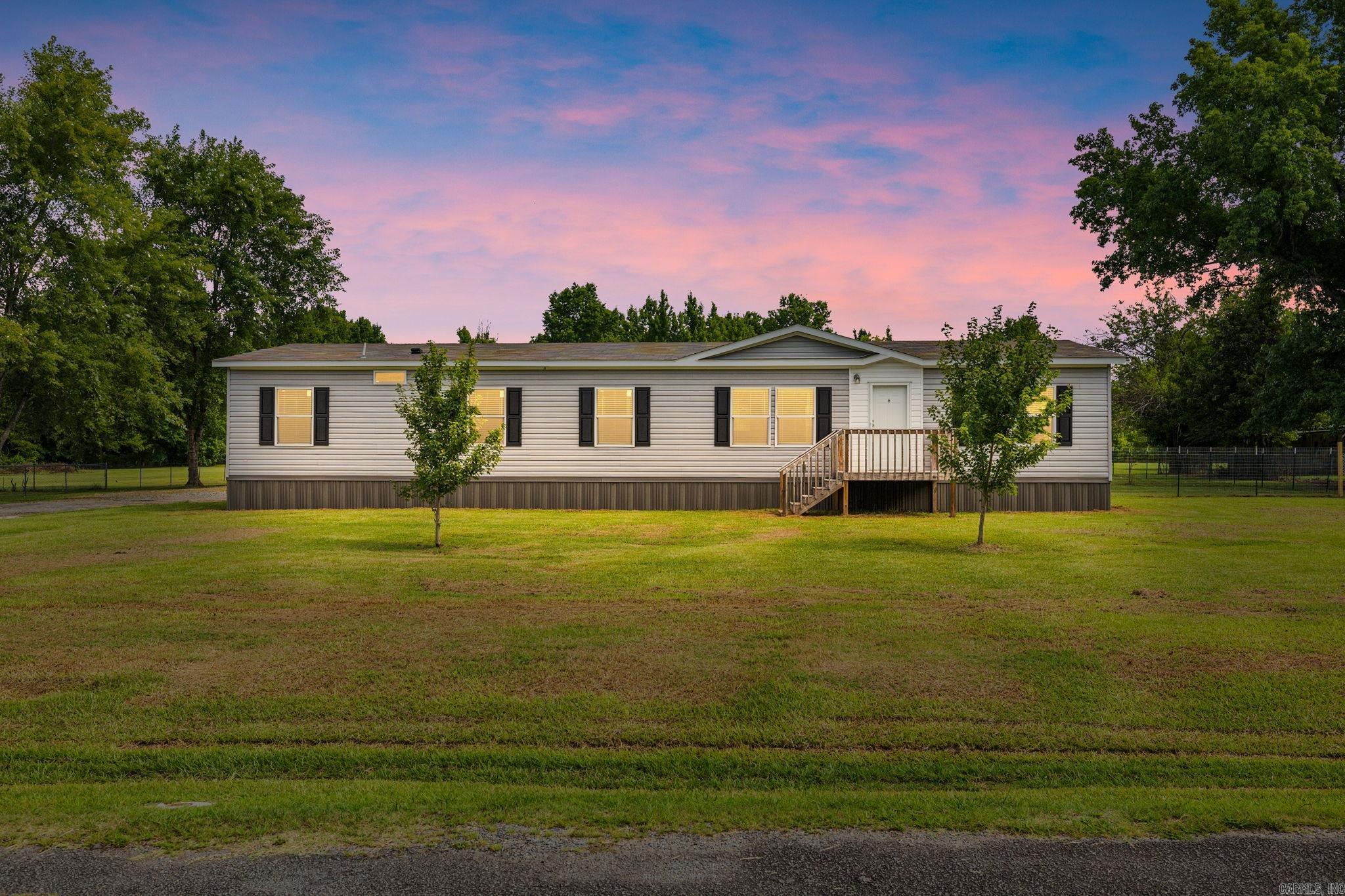 Farmhouse Flair! This 5 Bedroom, 3 Bath home leaves nothing to be desired! Located on 1.76 acres, with quick access to interstate, this home offers land, location, and loads of space! The open style floor plan, with Primary split apart, offers comfort and convenience for family and guests! Enjoy picturesque views from the stylized Kitchen, complete with stainless appliances (including refrigerator), spacious island, ss drop in sink and tons of storage! The Primary Bath is loaded with upgrades: tiled, walk in shower; luxurious soaking tub; and shiplap for a farmhouse flair! Enjoy your morning coffee on the covered deck overlooking the tree lined yard, storage shed, playground, and fenced space for beloved pets! Schedule your private showing today! Agents see remarks.