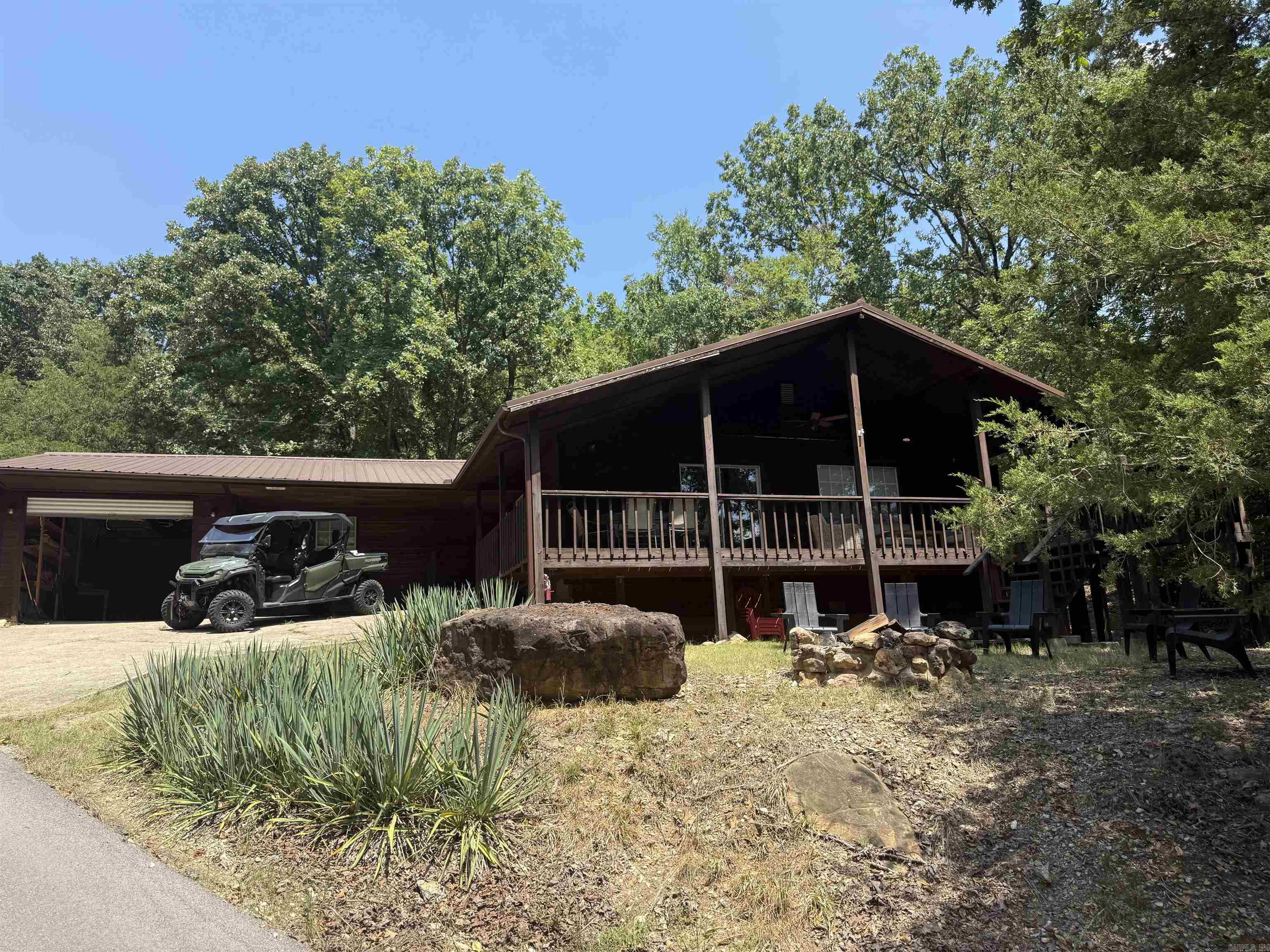 Welcome to this stunning 3 bedroom, 3 bath Lakeview home offering the perfect blend of comfort and character.  Step inside to find a light-filled living area featuring a soaring ceiling with exposed wood that creates a warm, inviting atmosphere.  The kitchen and bathrooms shine with freshly painted cabinets and trim giving a crisp updated look.  Enjoy morning coffee or evening sunsets on the wrap around deck, perfect for entertaining.  Outside, gather around the fire pit and take in the peaceful surroundings.  This home also features a large garage with a work area and built in shelves, providing plenty of storage and space. HOA $150 annually.