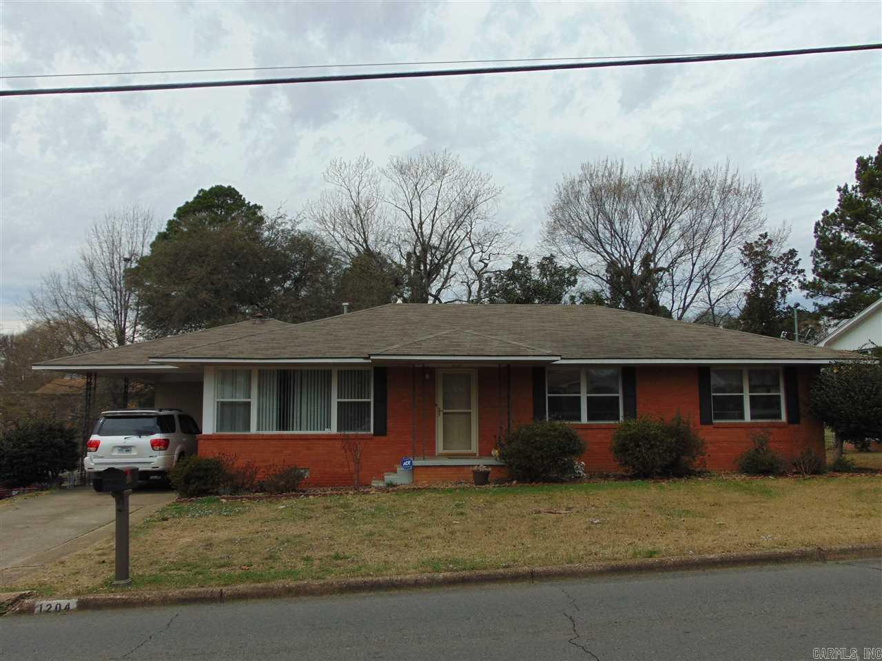 Charming Family Home is so Convenient to Shopping, Hospital, Entertainment - You Name it! Light and bright inside, with large picture windows, updated paint, original resurfaced hardwoods, 3 good size bedrooms, mature trees, covered, screened back porch overlooks large fully fenced backyard, and there's a storage building plus outside storage room for your "stuff". Solid, mostly brick, this is a great home and you can feel the love when you walk in. Call for your appointment today!  **AGENTS SEE REMARKS**