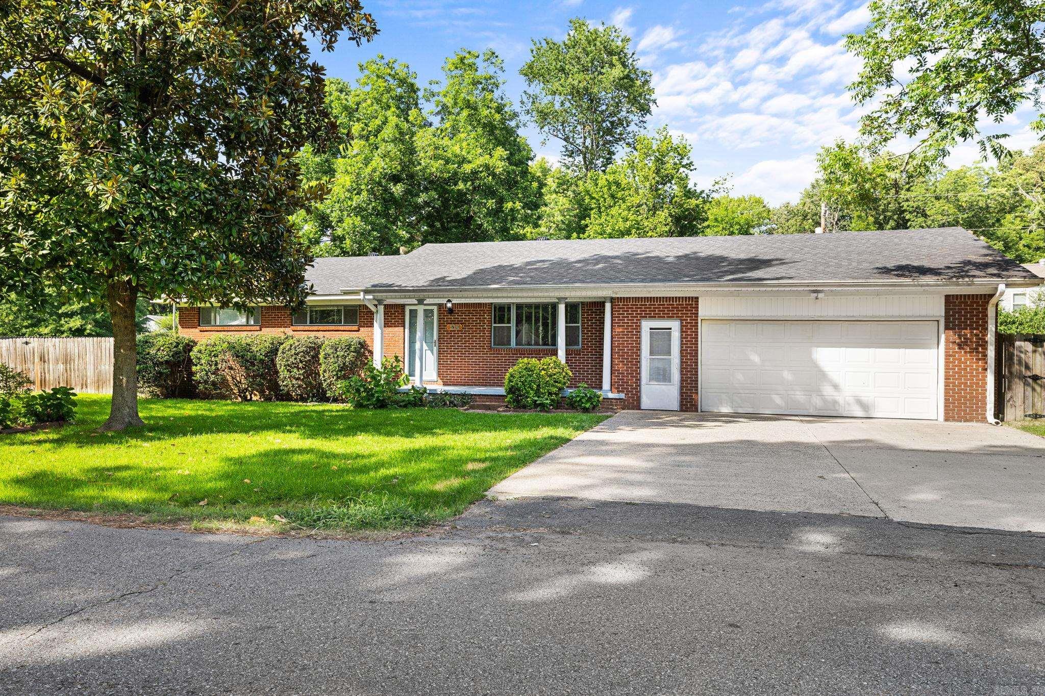 Welcome to this beautifully updated 4-bedroom, 2-bath home offering 1,517 sq ft of move-in-ready living space! Inside, you'll find durable laminate flooring throughout with no carpet, creating a clean, modern look that's easy to maintain. The updated kitchen is both stylish and functional, stainless steal appliances, the refrigerator will convey. The washer & dryer also stay, making this home truly move-in ready. Step outside and discover one of this property's standout features—a spacious yard spanning three lots, offering endless possibilities for gardening, entertaining, play, or simply enjoying the outdoors. Garden enthusiasts will love the established raised garden beds, blackberry bushes, raspberry bush, mature pecan trees, and plum tree that all remain with the property. Additional highlights include a 14' x 17' storage shed for all your tools and hobbies, a 6' x 6' safe room located in the garage for added peace of mind, and a security system that conveys with the home. Garage has extended shop space as well. With thoughtful updates, exceptional outdoor space, and valuable extras throughout, this property is a rare find. Sits on .94 acres. Property to be sold "As Is"