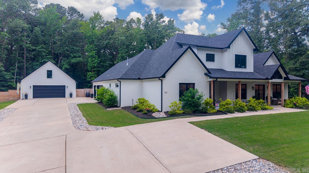 Welcome to 810 Caddo, a stunning custom-built estate built in 2023, perfectly situated on 3 private acres within the Woodlands subdivision, offering the rare blend of luxury living and neighborhood amenities. This exceptional 4-bedroom home features two luxurious main-level ensuite bedrooms, a private office that could also be a dining room, an oversized laundry room, and a designer pantry complete with small appliance cabinets for effortless organizing! The heart of the home opens seamlessly to an incredible pool house/game room featuring a full bath and a dramatic glass overhead door that extends the living space onto the resort-style outdoor patio and sparkling pool w/hot tub! Upstairs, you'll find two spacious bedrooms connected by an oversized J&J bath, along with an additional loft living space perfect for work or relaxing. Every bedroom offers massive walk-in closets with built-in dressers. Outdoors, enjoy multiple inviting, relaxing areas, a fully equipped outdoor kitchen with built-in grills, sink, ss drawers & bar seating - all designed for elevated entertaining. Completing the custom masterpiece is a 30x30 Heated/cooled shop with a fully floored attic for great storage!