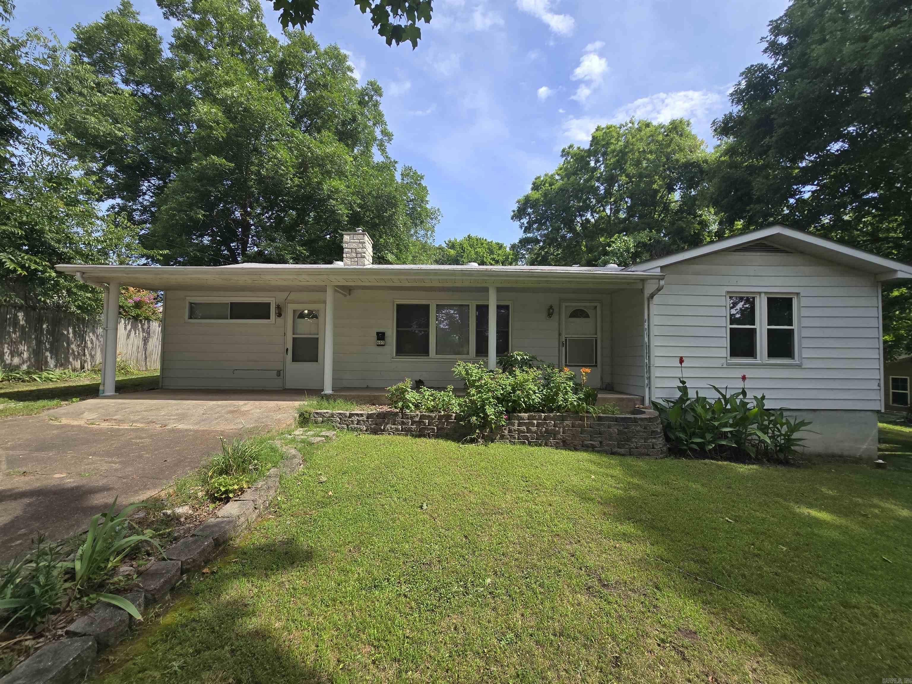 Lovely 3-bedroom, 2-bath home with real hardwood floors and a pellet stove in the living room. This property is not part of a subdivision and sits on a beautifully maintained half-acre lot that offers a private feel while still being within city limits. The country kitchen features original cabinetry, and major updates include a roof less than 5 years old, newer HVAC, and newer water heater. With 1,606 sq. ft. of living space, the home offers four separate entrances for added convenience. A gravel drive extends along the house to a 2-car carport located behind the home. There is also a storage shed with an attached carport, perfect for parking a mower. Enjoy the best of both world, peaceful living with the convenience of being just a few blocks from Mountain Home's downtown Baker District, a vibrant destination featuring locally owned restaurants, shops, a brewery, live entertainment, community events, seasonal festivals, and the farmers market! Listed at $230,000