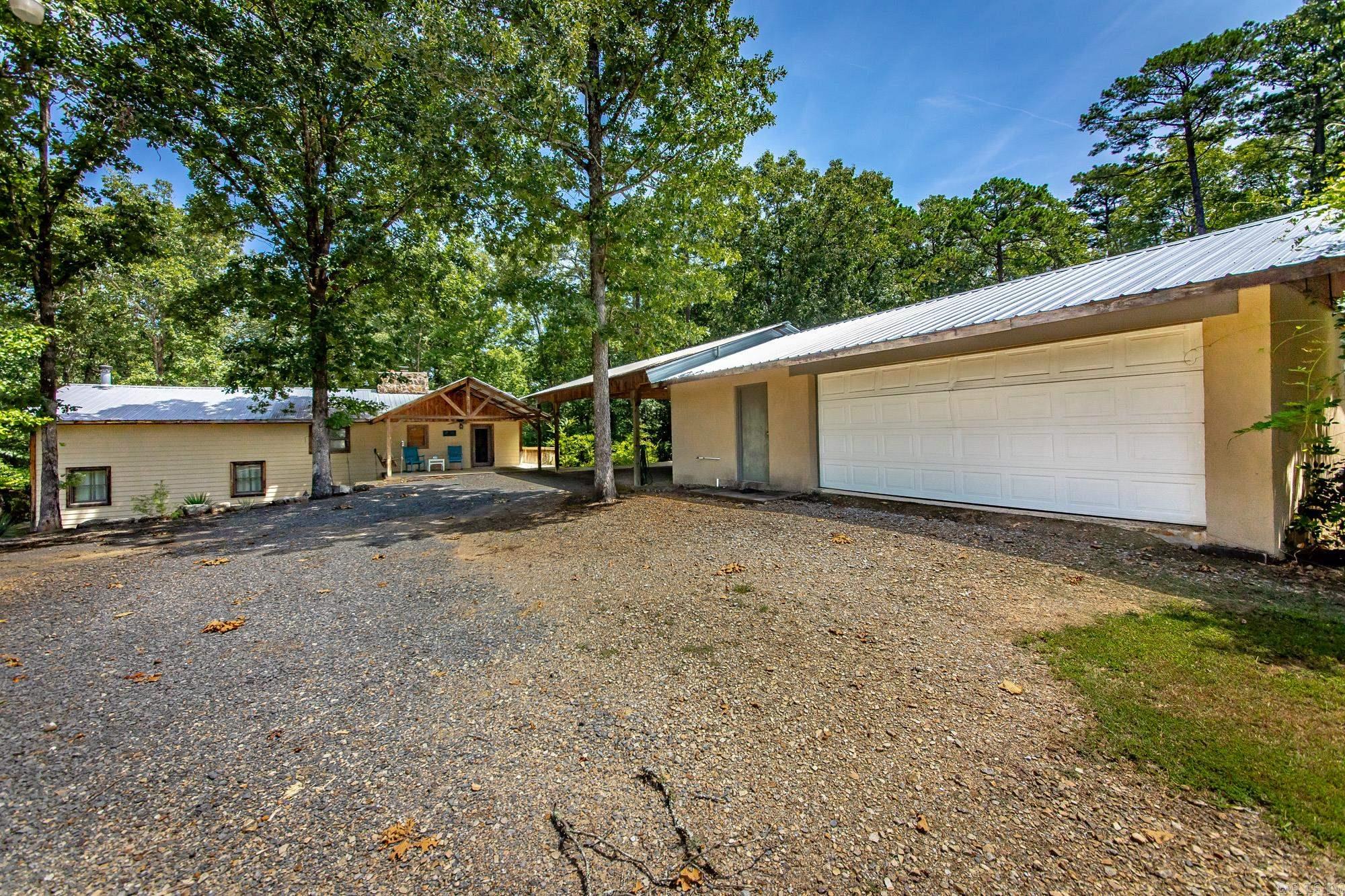 Fully furnished lakefront home on 3.72 acres in Higden, with the Corps of Engineers “white line” bordering the property and a permitted path leading to the water. This 2,436 sq. ft. two-level home features vaulted ceilings, a spacious den with bar area, dual fireplace, and wood-burning stove. Enjoy outdoor living on the large back deck or relax in the hot tub while surrounded by abundant wildlife. Property includes a metal roof, detached 2-car garage/shop, carport, additional covered boat storage, circular driveway, and RV parking with hookups. The private wooded setting offers a great combination of seclusion and lake access. Ideal as a full-time residence, vacation home, or investment property on Greers Ferry Lake, with boating, fishing, hiking, and outdoor recreation nearby.