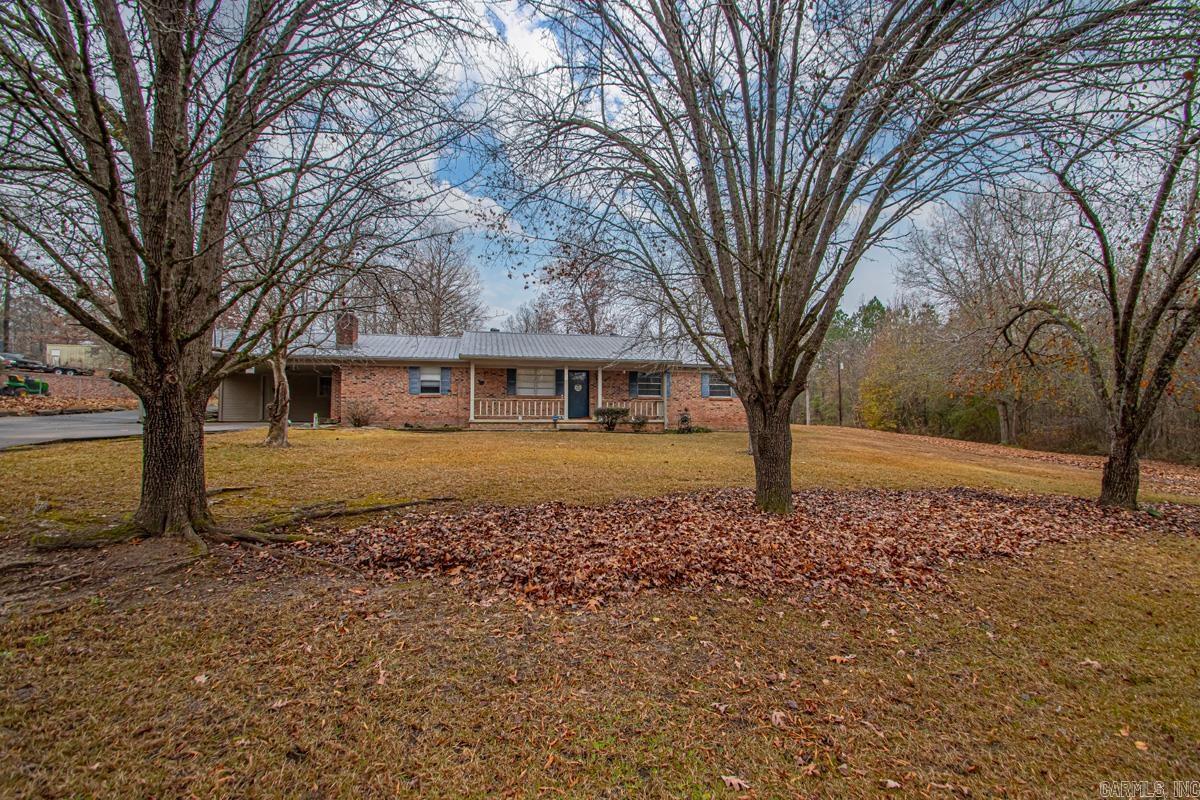 The listing you’ve all been waiting for! Beautiful wooded acreage, a massive shop, and major updates already done — including a new roof (2015) and HVAC (2016) — make this the perfect place to call home in a peaceful country setting. The home sits on one lot plus an additional wooded lot to the right, offering extra privacy and space to enjoy. Step inside and you’ll immediately feel the warmth and coziness of the spacious living room. There’s also a separate den featuring a wood-burning fireplace, perfect for relaxing evenings. The open-concept kitchen and dining area offers plenty of cabinet and countertop space and flows nicely for everyday living or entertaining. A large laundry room leads to an additional craft or flex space, giving you even more room to customize. The primary and secondary bedrooms and bathrooms are generously sized, with updated bathrooms that include shower/tub inserts, updated plumbing fixtures, and new toilets. Outside, you’ll find the spacious shop with roll-up doors, ideal for hobbies, storage, or projects. This property truly has so much to offer — space, privacy, and key updates already in place. Don’t miss your chance to make it yours!