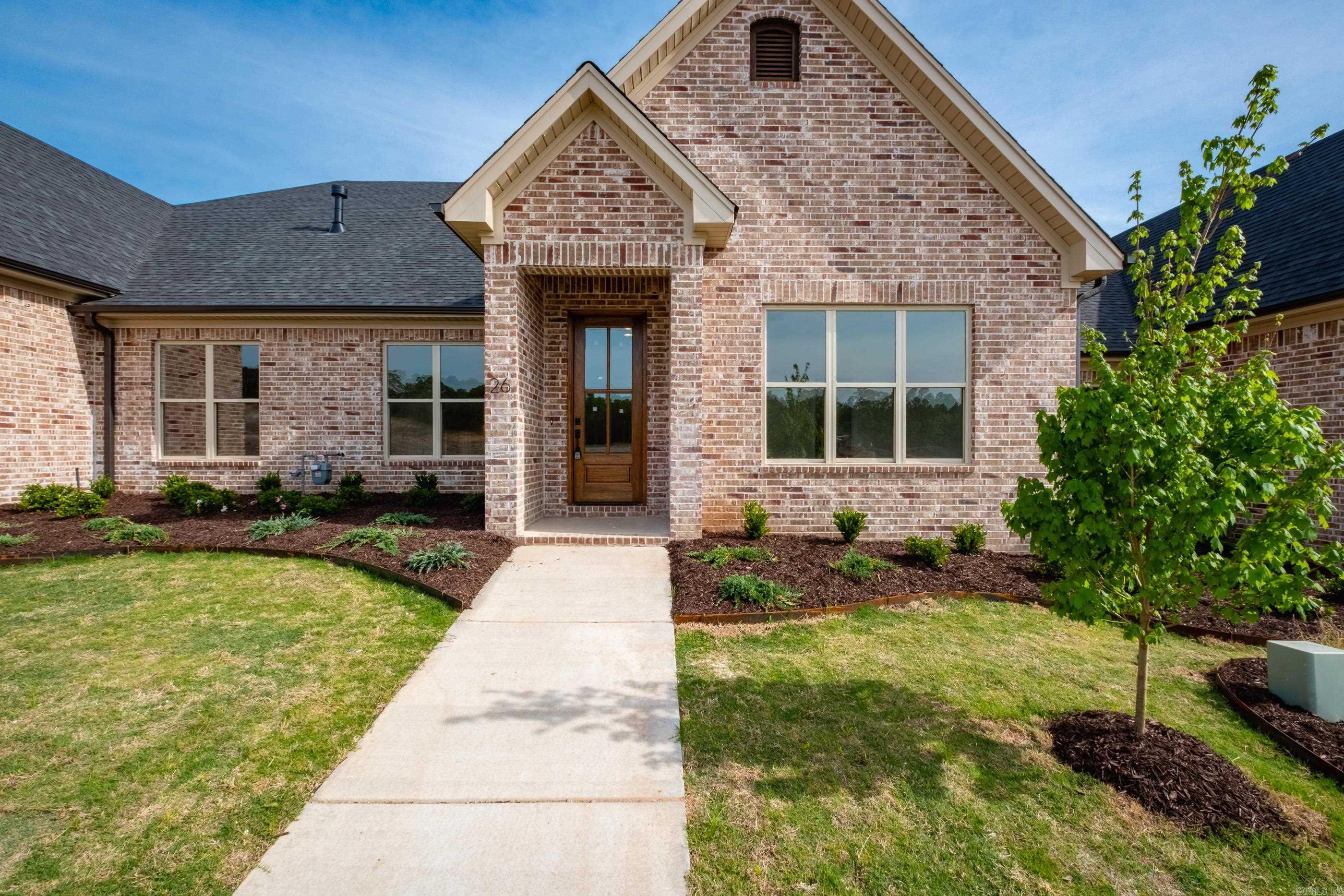 Welcome to Edgewood, West Little Rock’s newest neighborhood where upscale living meets low-maintenance convenience. Built by Graham Smith Construction, this thoughtfully designed 2-bedroom, 2-bath attached home offers modern comfort with no yard work required—lawn care is included. Step inside to a bright, open-concept layout with designer finishes at every turn. The living area features a cozy fireplace and flows seamlessly into a sleek kitchen outfitted with quartz countertops, custom cabinetry, stainless steel appliances, and a stylish tile backsplash. Luxury vinyl plank flooring runs throughout the home, adding warmth and durability. The primary suite is a calming retreat with a spacious walk-in closet, a large vanity, and a tiled shower. Enjoy outdoor living on your private, covered patio, perfect for morning coffee or evening unwinding. A 2-car garage adds parking and additional storage. Located just 3 minutes from Costco! Edgewood offers easy access to all that Little Rock has have to offer. With early-phase availability, now’s the time to invest in this beautiful new community. Set for completion March 2026.