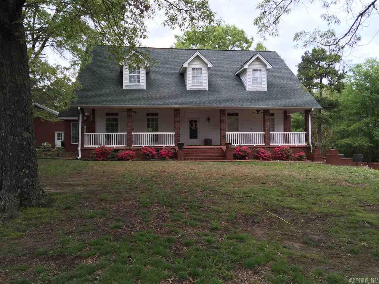 Impressive 2 story brick in the country with room for kids and horses! It has a huge master suite downstairs with 2 bedrooms and large bath up. Holidays will be a joy in the spacious kitchen featuring granite counters, stainless appliances, and travertine floors. Wood burning fireplace in the great room. Entertainment area upstairs w/pool table and wet bar. Lots of parking and an all brick, 4 car garage with a full bath. Owner offers $5000 to buyer at closing with a full price contract. Agents-see remarks.