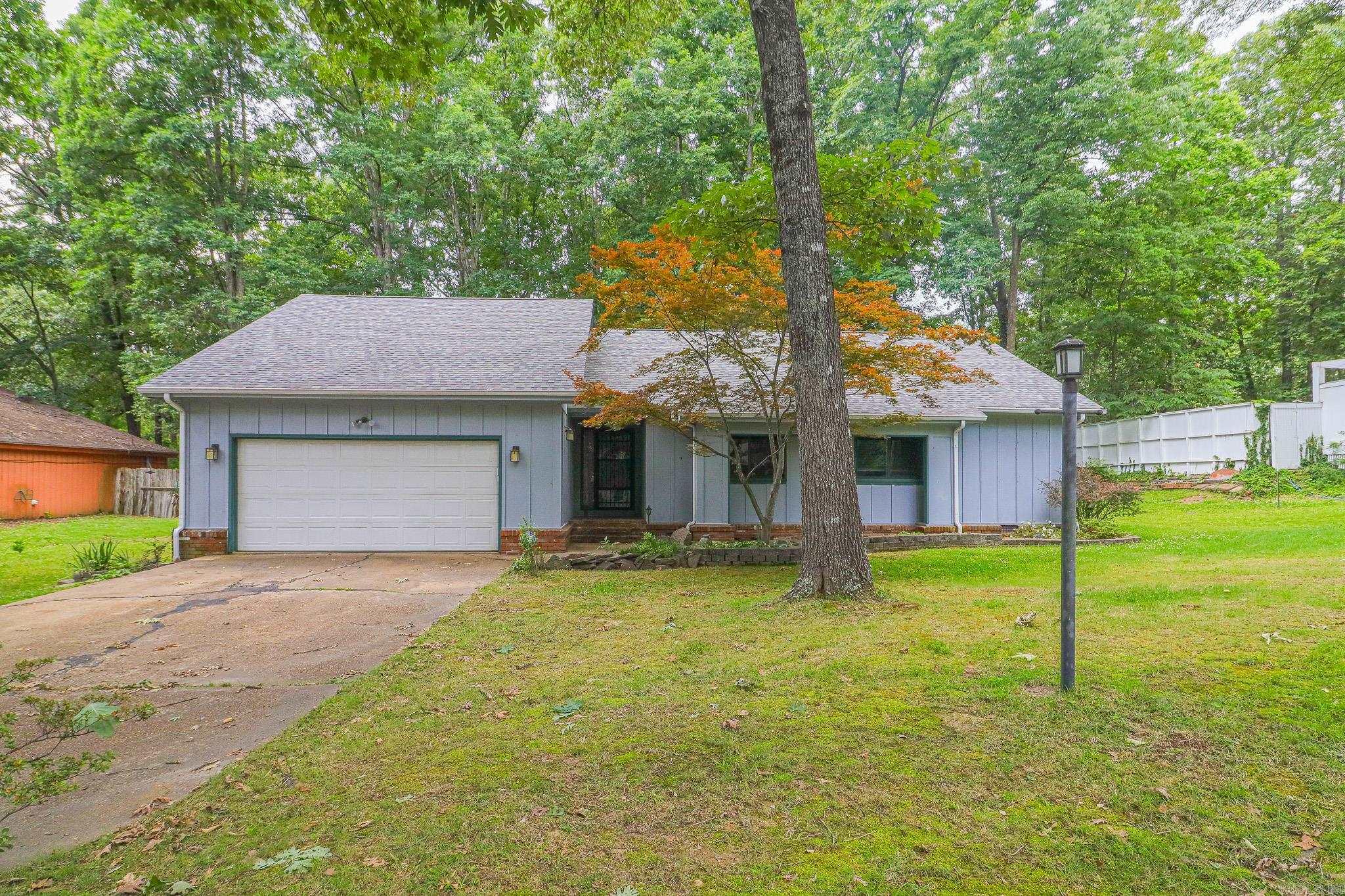 Great three bedroom, two bath home in a desirable neighborhood featuring a spacious living room with abundant natural light. The primary suite offers cedar walls and ceiling, plus a walk-in closet with built-in drawers. Flooring includes brick in the entry, carpet in the living room, tile in the kitchen and dining area, and laminate throughout the remainder of the home. Enjoy the large deck overlooking numerous mature shade trees and partially fenced yard. Stainless french-door refrigerator with bottom freezer. Washer and dryer all convey. A wonderful combination of comfort, character, and convenience.