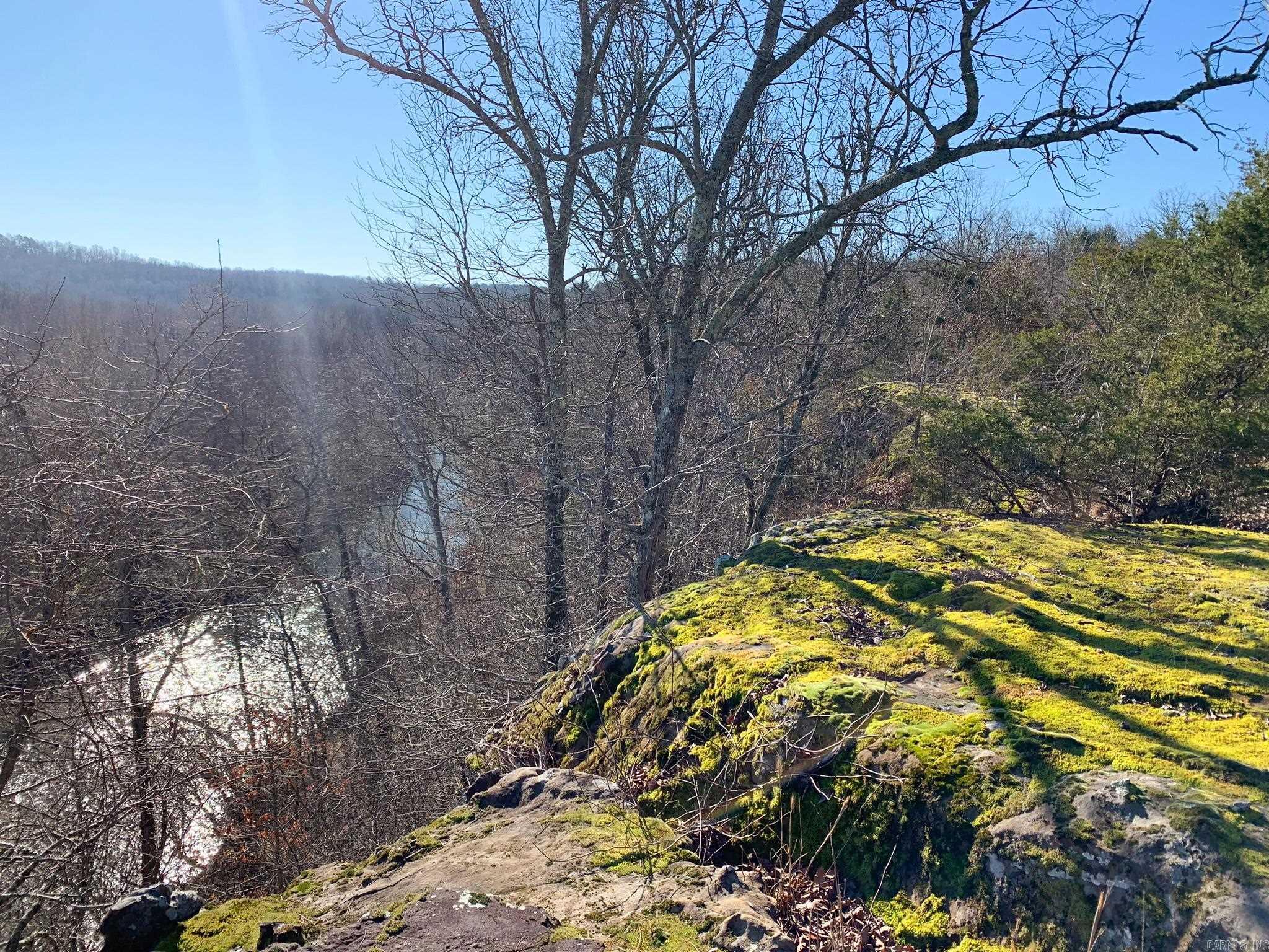 Build your getaway cabin overlooking a breath-taking view of the Cadron Creek valley, nestled amongst the gateway to the Ozarks. This 4.54-acre tract runs all the way back to the center of the gorgeous, year-round North Fork of the Cadron Creek. Rock bluffs jut out above the creek and make for amazing views across the creek valley. Rock shelfs and shelters dot the hillside. This tract has lots of wildlife and is peaceful and secluded -- almost entirely surrounded by other wooded tracts and with access from a quiet dead-end county road. This is the perfect place for a private residence, getaway cabin, off-grid build, hiking,  fishing... you name it! Electric and water are available along Odom Point Rd. Only a 20-minute drive to Choctaw Marina on Greers Ferry Lake and one hour from Grinder's Ferry on the Buffalo National River. No mobile homes allowed.