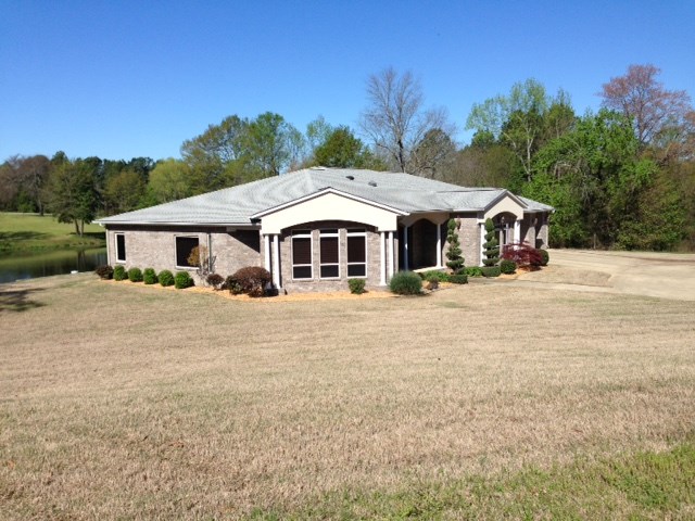 In town privacy with a water feature accentuate this custom built 3 bedroom, 2 bath home. Ceramic tile through out all living areas. Bedrooms are carpeted. The kitchen is a chef's delight with a large granite island, stainless steel appliances and desk area. All appliances convey including washer and dryer. Custom built cabinets and accents are through out the house. The large office could be used for a fourth bedroom. The garage has capacity for 4 cars. Enjoy the solitude or entertaining on the back porch.