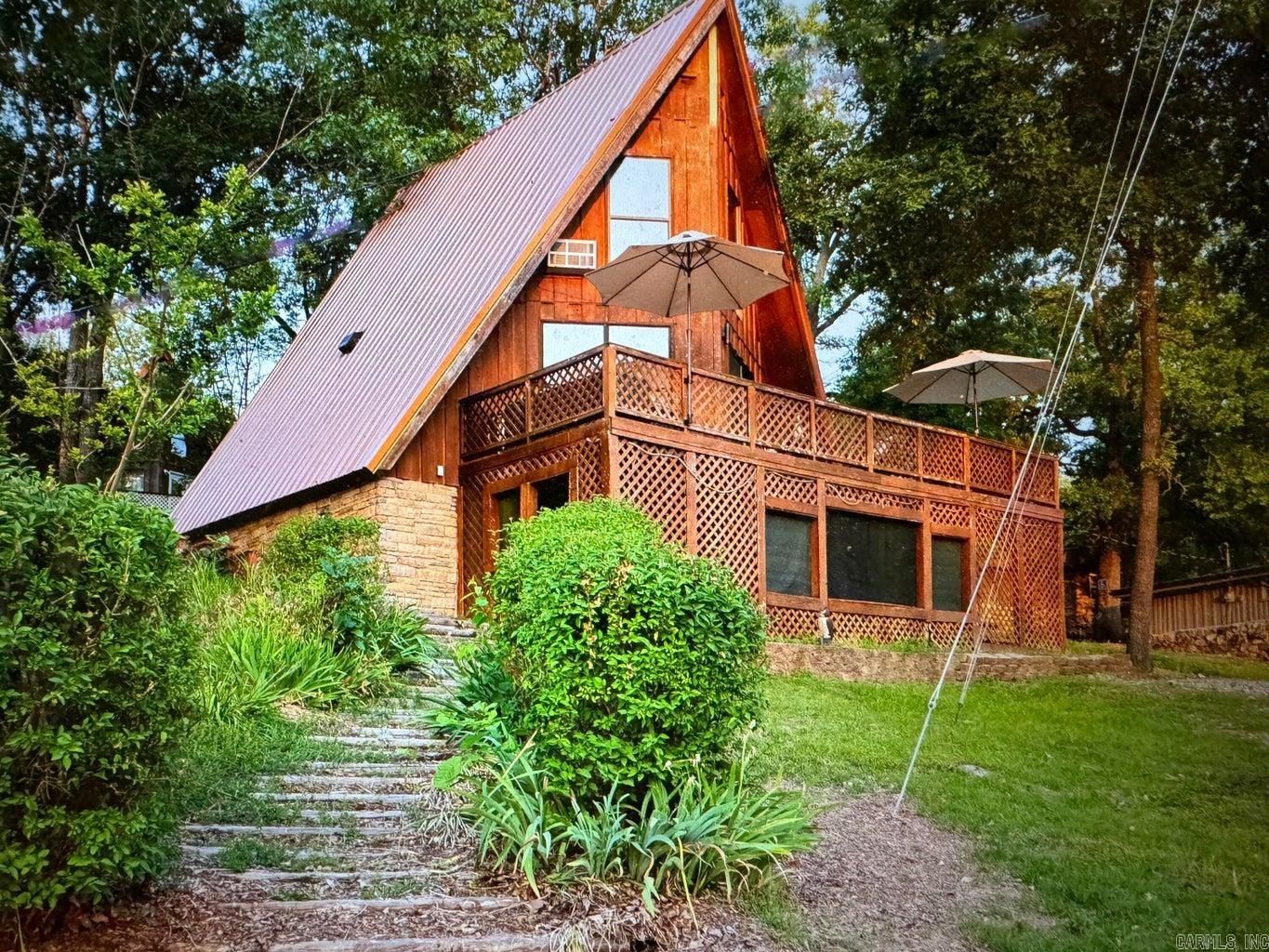 Super neat furnished A-frame cabin with lake view. Home has a metal roof and is updated and ready to go! This one bedroom A-frame has a full and a half bath, as well as an open floor plan. Large deck with a lake view to enjoy outdoor living or just sit and watch the sunsets.