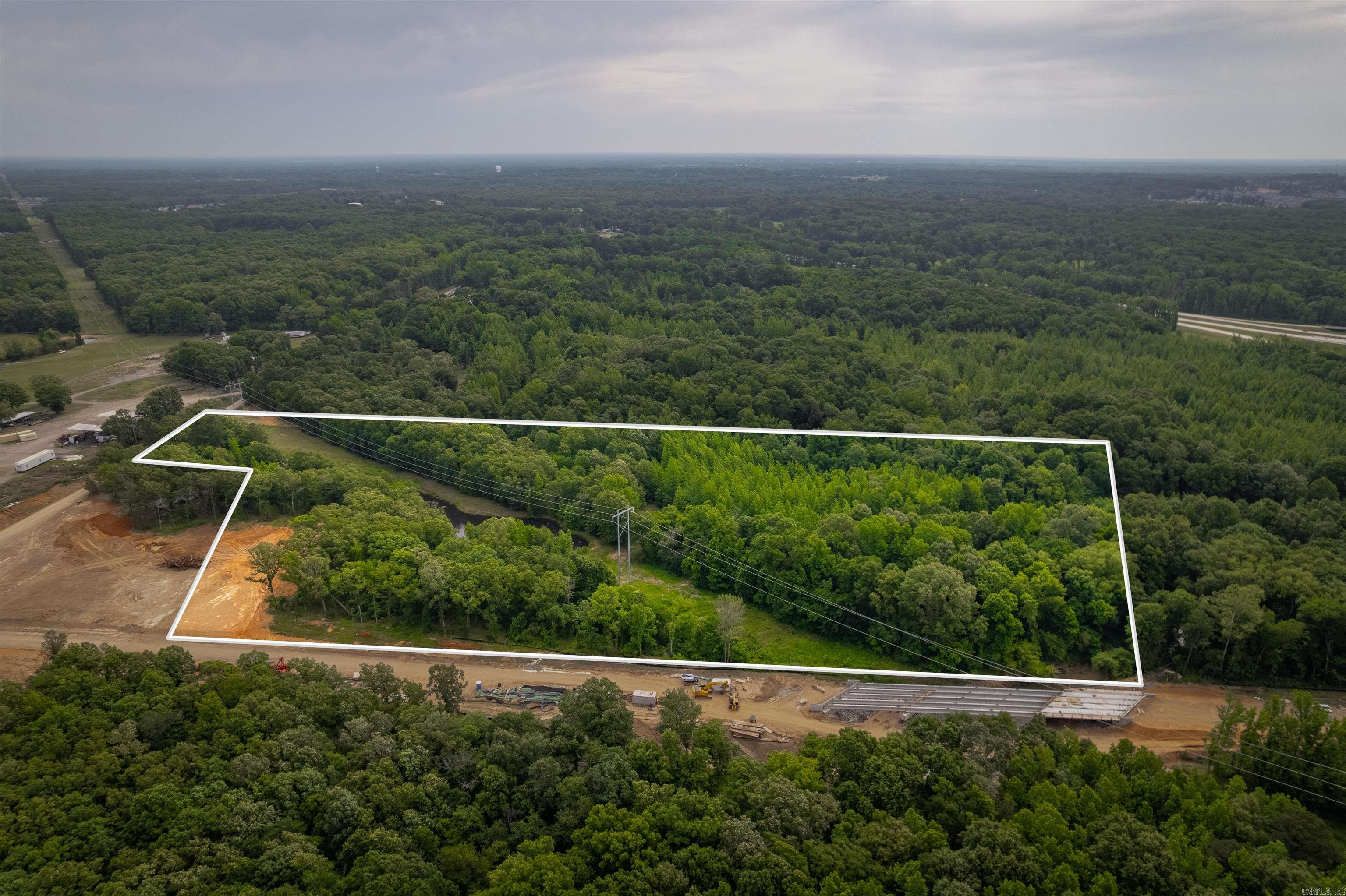 Rare and Amazing Opportunity Here! This property has approximately 200' Road Frontage on Ernie Davis Road.  This property also has approximately 900' Road Frontage on the New Road being built at Exit 21 near Game Time at the Grounds and the Future Lyon College Veterinary School. This property has utilities at the road. This property could be developed in many ways, such as, a build site for a large apartment complex, convenience stores, shopping center, restaurant, office complexes, multi-use (upstairs condo/apartment & downstairs retail) and much, much more! This property will be located on a very busy road in the near future, that will provide service extending towards Cabot's Greystone, Austin's George's Crossing & Valley View subdivisions in Austin and more!  This property has significant potential for an investor to turn this into a positive income producing property! Also, check out Lots 1 and 3 too! The sketch provided is NOT a Survey.  Utilities located at roads.  Official Legal Description, Acreage and Dimensions shall be defined by a New Survey.   SEE AGENT REMARKS.