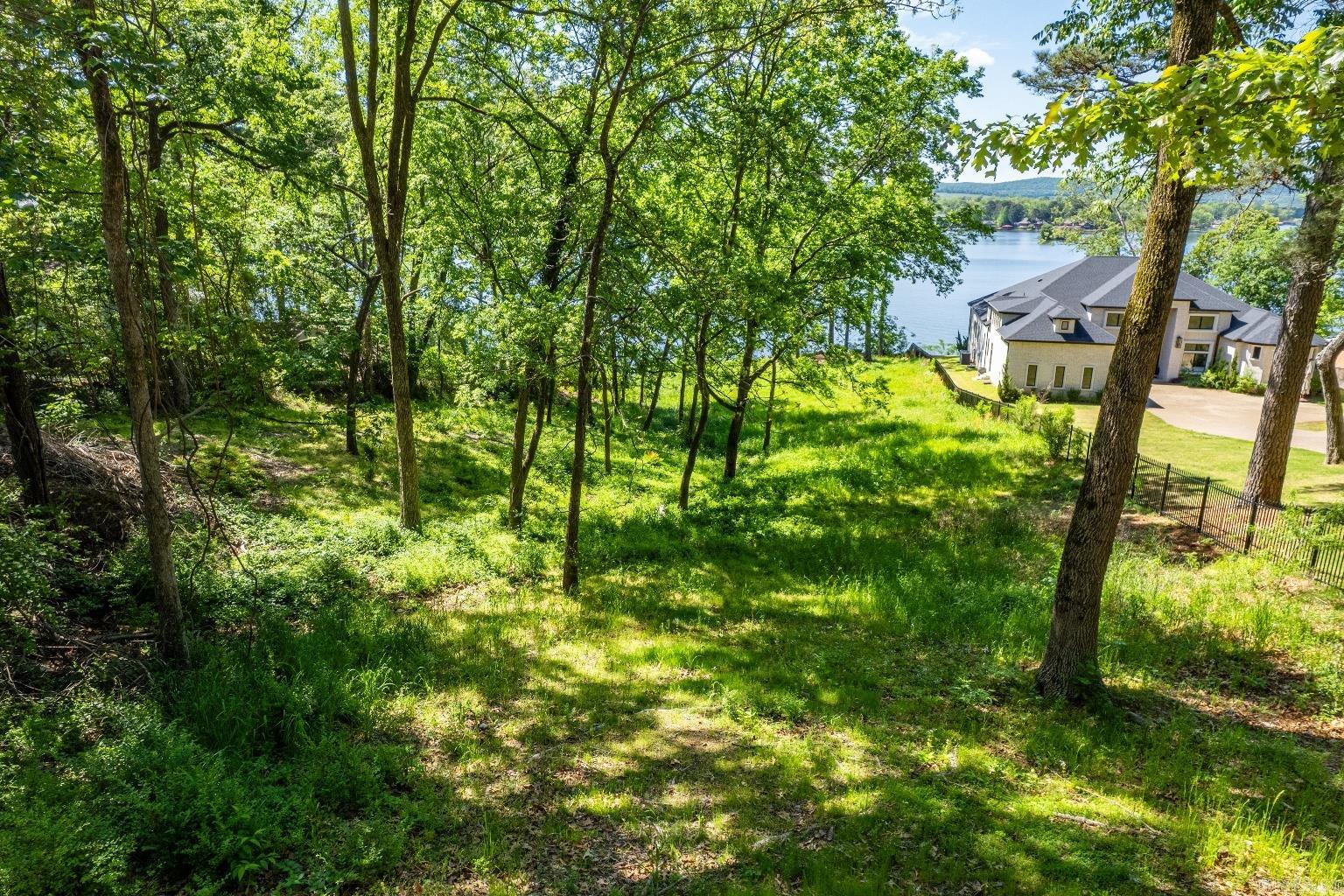 Gorgeous lake views and 145 feet of lake frontage on Lake Hamilton. Close to Garvan Gardens, your summer never smelled so sweet!  Grab your house plans and pack your bags, it's time to build your dream home!