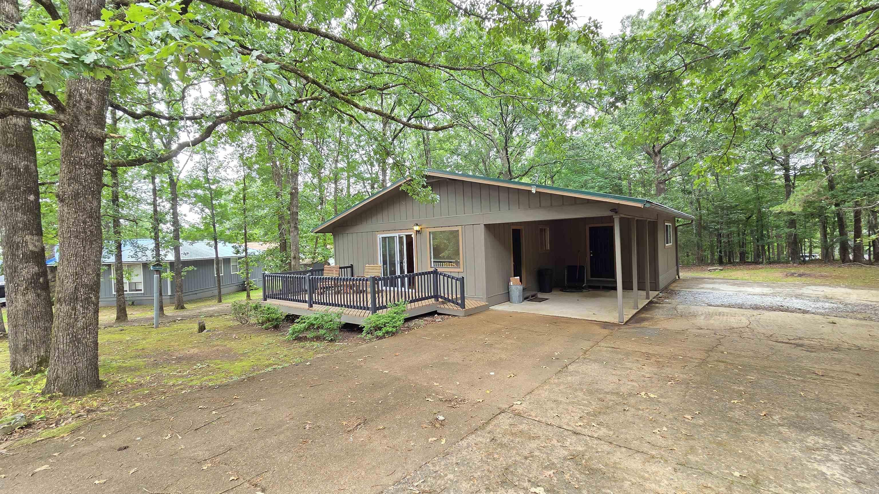Enjoy the beautiful Lake view from the newley painted deck, new paint inside and out, many new doors and windows, comes mostly furnished,  covered carport,  concrete pad parking enough for truck and trailers extra outdoor storage & an extra large laundry room that could be remodeled perfectly for a large master bathroom, walk in closet & stay a large laundry room too!   See other great reasons to live in this resort town!  This resort town offers so much!  This home is also on its own private septic, which lowers your monthly costs!  Fiber internet is available too!