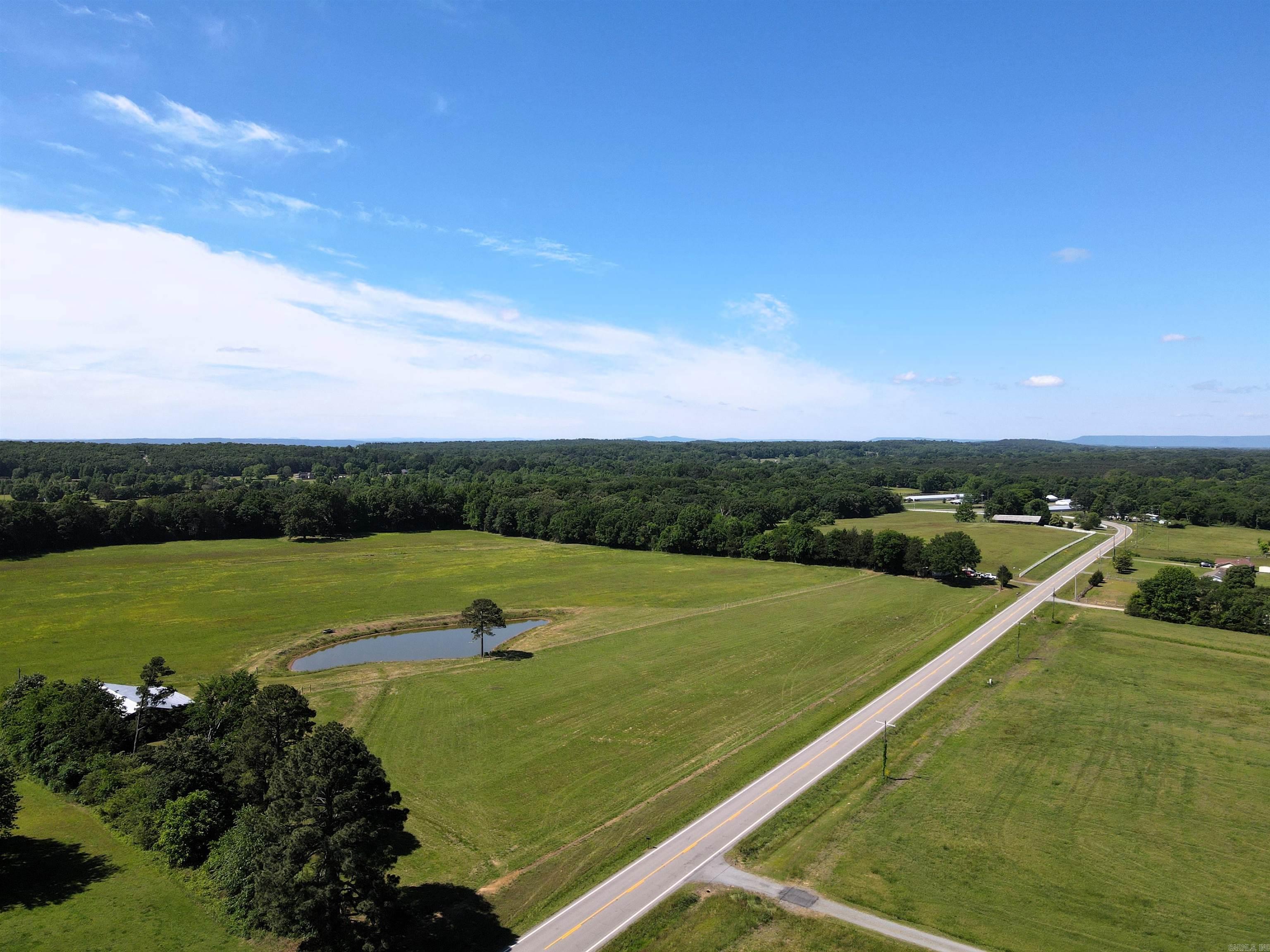 This 1.27 +/- acre tract offers a straightforward path from purchase to building. The land is mostly level, backed by a recent survey, and sits outside the flood plain, giving you confidence in what you’re buying and where you can build. With power and county water available, much of the groundwork is already in place. The highway frontage provides easy access, whether you’re planning a home, shop, hobby farm or small investment project. Minimal restrictions give you the flexibility to make it your own without unnecessary limitations. Conveniently located just 7 miles to Morrilton and 16 miles to Conway, you’ll have quick access to everyday essentials while still enjoying a quieter setting. The land is being offered as a whole or in 4 equal tracts of 1.27+/- acres at $50,000 per tract. A clean, usable piece of land that’s ready for your next step.