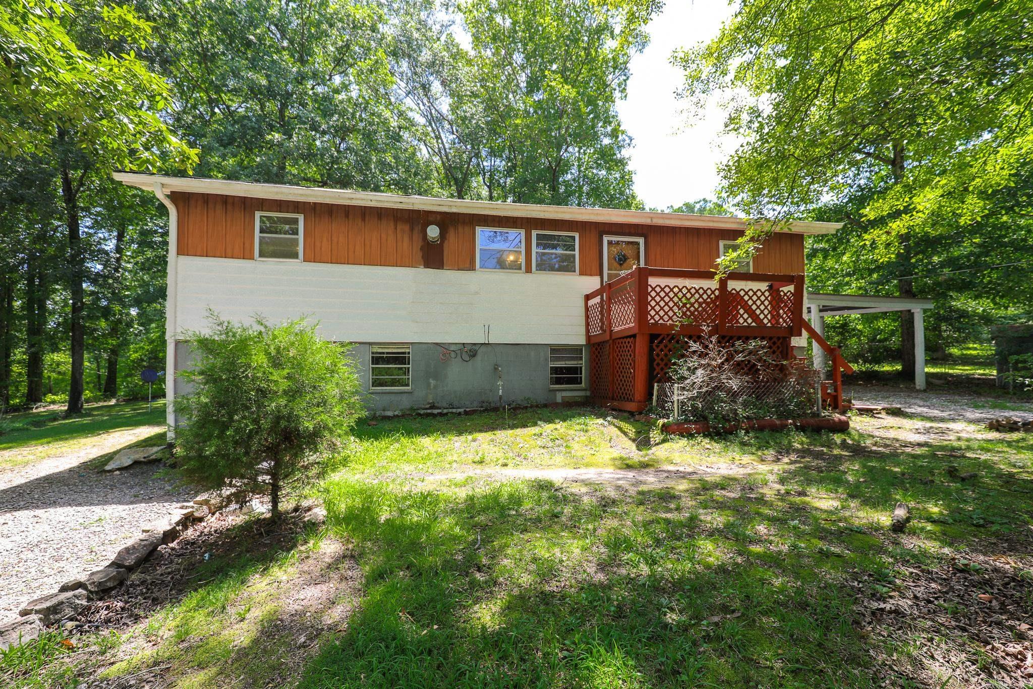One owner country home with a shop plus two additional barns/outbuildings. Home is appx 1230 square feet with a full basement the same size. Basement is full block construction and is liveable. Large eat-in kitchen. Beautiful hardwood floors in the  living area. Front and back decks. Carport. Shop is is cooled and has electricity. There is an RV hookup on the property. Three gorgeous, tree shaded, fully fenced acres. Home is an estate and there is no property disclosure and is being sold "as-is. Great opportunity to own a sweet country place with ample room for multiple families.