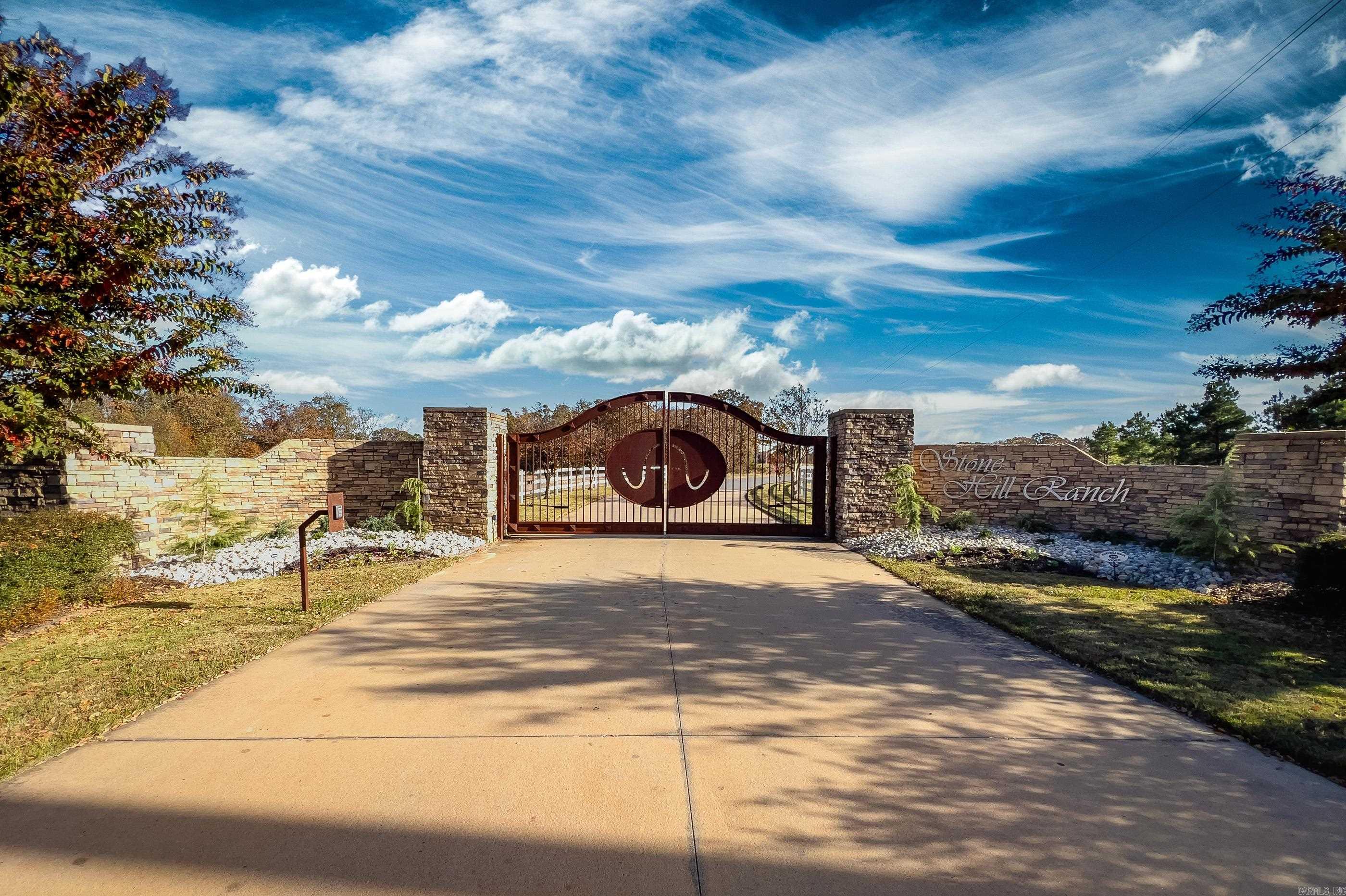 Beautifully distinct 10.3 acres on Palarm Creek within the Stone Hill Ranch gated community. The front 2.5 acres offers the perfect building site, which was resurveyed and lays above the 100yr flood plain. The lower back acreage offers 1600' secluded creek bank, a mature native pecan grove and rich pasture. The owners have a building site and custom house plans preapproved by the architectural committee available to the buyer. Septic plan and permit are approved. Water and Underground Electric from the road. Quick 10 minute access to I-40 then 5 min to I-430