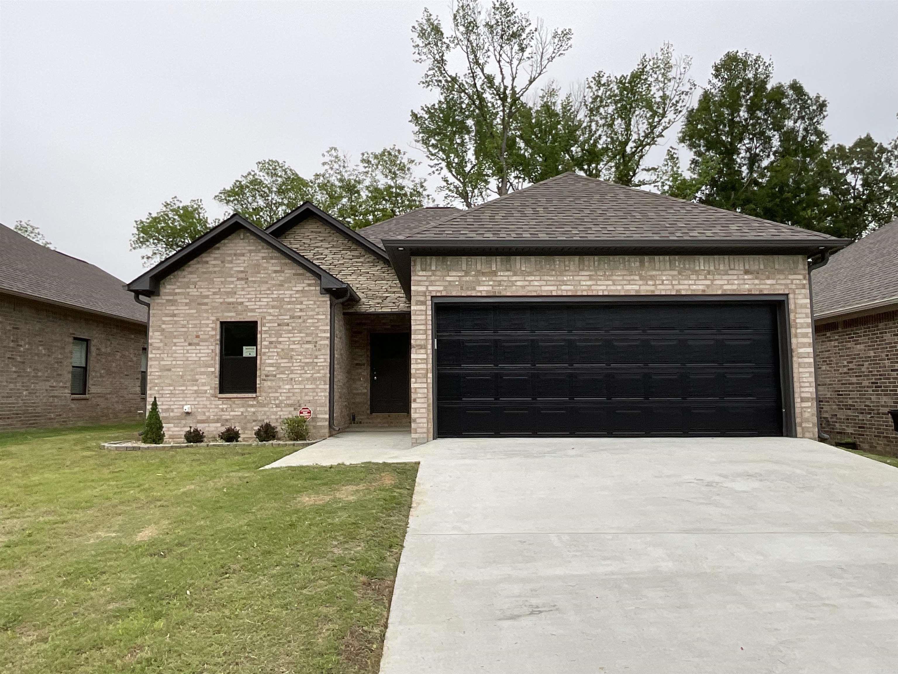 NEW CONSTRUCTION with a fresh, summer-ready vibe! From the soaring vaulted living room ceiling to the relaxing soaking tub, every detail in this beautiful Jacksonville home shines—featuring stylish black doors and cabinetry with matte gold accents, custom tile, and sleek quartz countertops. The 9' ceilings throughout create a bright, open feel, while the seamless flow leads to a back porch and spacious backyard perfect for summer evenings, grilling, or entertaining. Conveniently located with quick access to I-57, commuting to Little Rock is easy, and Little Rock Air Force Base is just around the corner—schedule your showing today and make this stunning home yours! SEE AGENT REMARKS