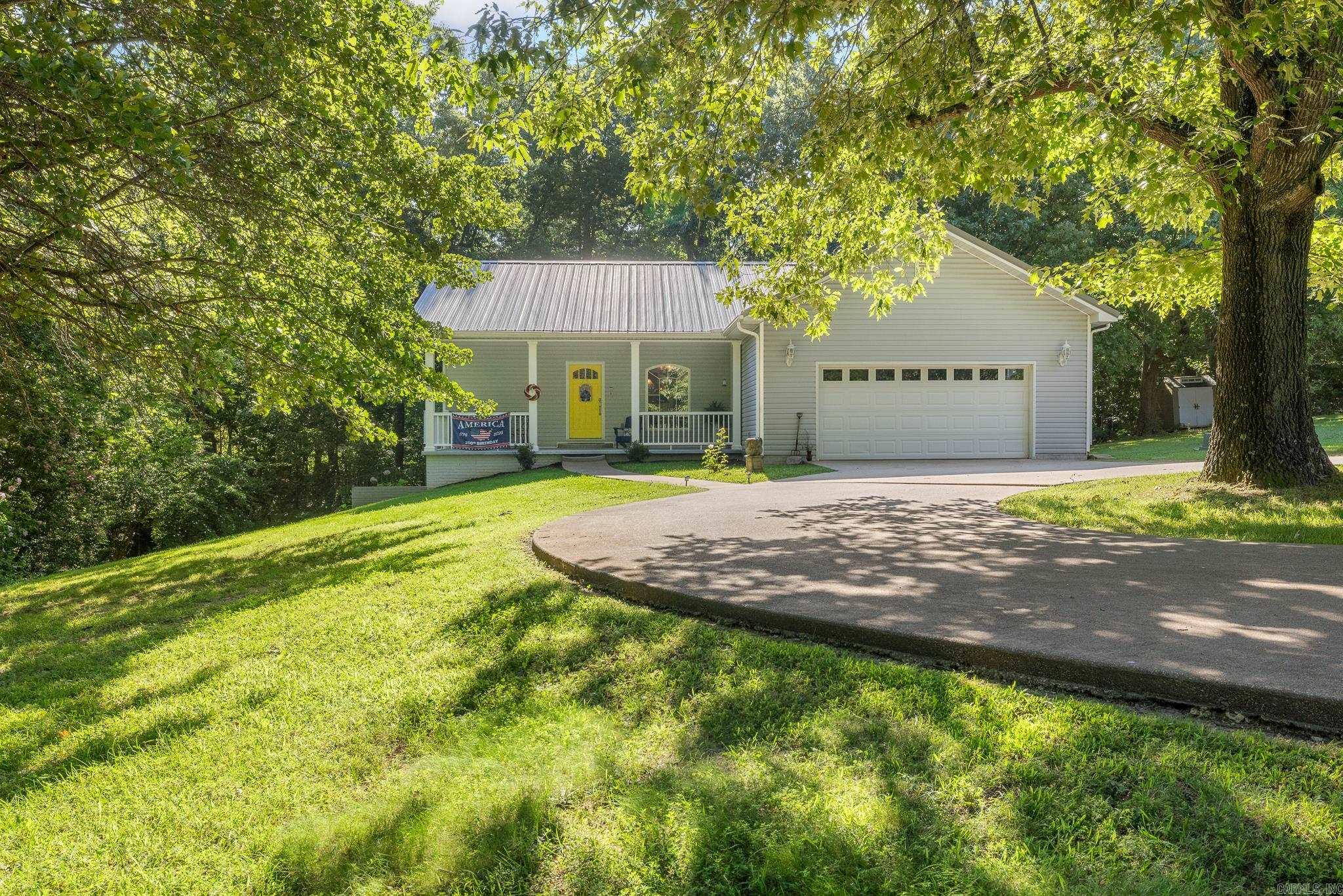 Tucked away in a peaceful, park-like setting on 3.85 acres, this property has 2,328 sq ft of living space (1,752 main home & 576 guest house). The main home features the primary suite upstairs, along with the kitchen, living room, and an attached 2-car garage, while the walk-out basement offers two nonconforming bedrooms, a full bath, and laundry room. The detached shop has been beautifully remodeled into a furnished 1-bedroom cabin that has generated $1,000 per month in rental income. It would work grEat as a home office, hair salon, accounting office, etc. Enjoy mornings on the composite back deck surrounded by mature trees, fruit trees, and a garden area. The additional lot enhances the feeling of seclusion while remaining less than 10 minutes from shopping, restaurants, and schools. This one-of-a-kind property offers the privacy of country living just minutes from town. For added peace of mind, the seller is including a one-year American Home Shield - Shield Plus warranty.