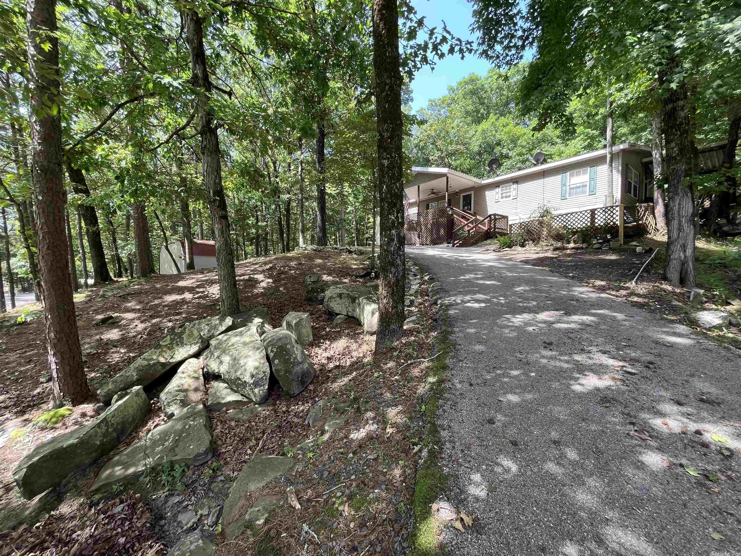 Bring the Boat! Weekend getaway or Home Sweet Home!  Located less than 1 mile from Cove Creek Rec. Area and Boat Launch at beautiful Greer's Ferry Lake.  Very well maintained mobile home in excellent condition on permanent foundation.  The house sits on 2 lots, approx. .5 acre of shaded, low maintenance lawn.  Features incl. wonderful kitchen, master suite w/standing shower & garden tub, lots of storage, walk-in closets, large bedrooms, very nicely finished deck, WMA Land behind the house. VRBO potential!