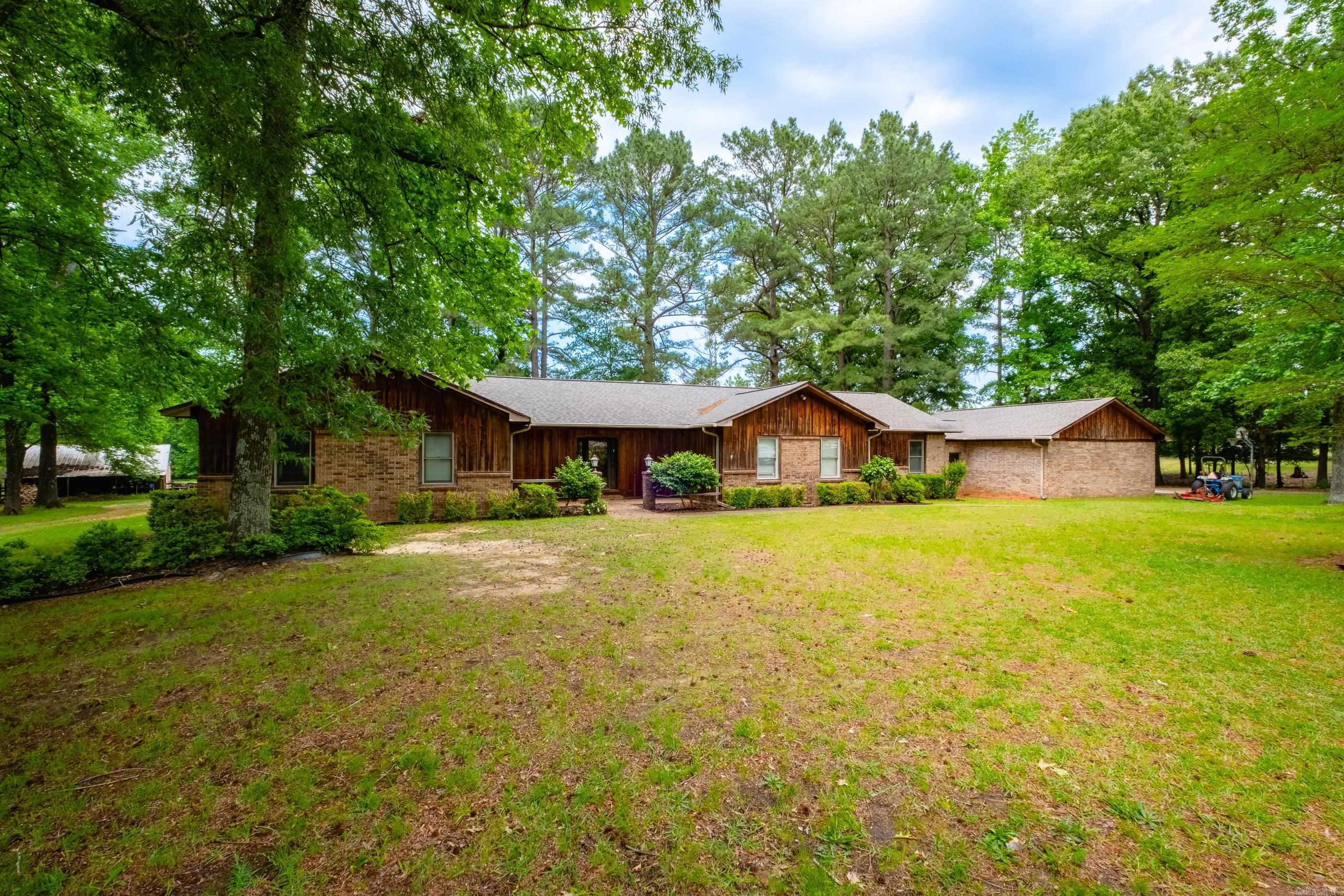 Stunning 10 acres fenced, crossfenced and complete serenity! Pasture land and approximately 5 acres of timber. Barn includes stalls, hay storage, feed/tack room  with plumbing and electricity. Ranch home with everything on one level including 3bed+large office and built-ins everywhere! Open floor plan with two living areas, tons of light, 3 car garage, tornado shelter and tons of light. Roof 2023, HVAC - 2024 and HWH - 2022. Property is on two parcels.