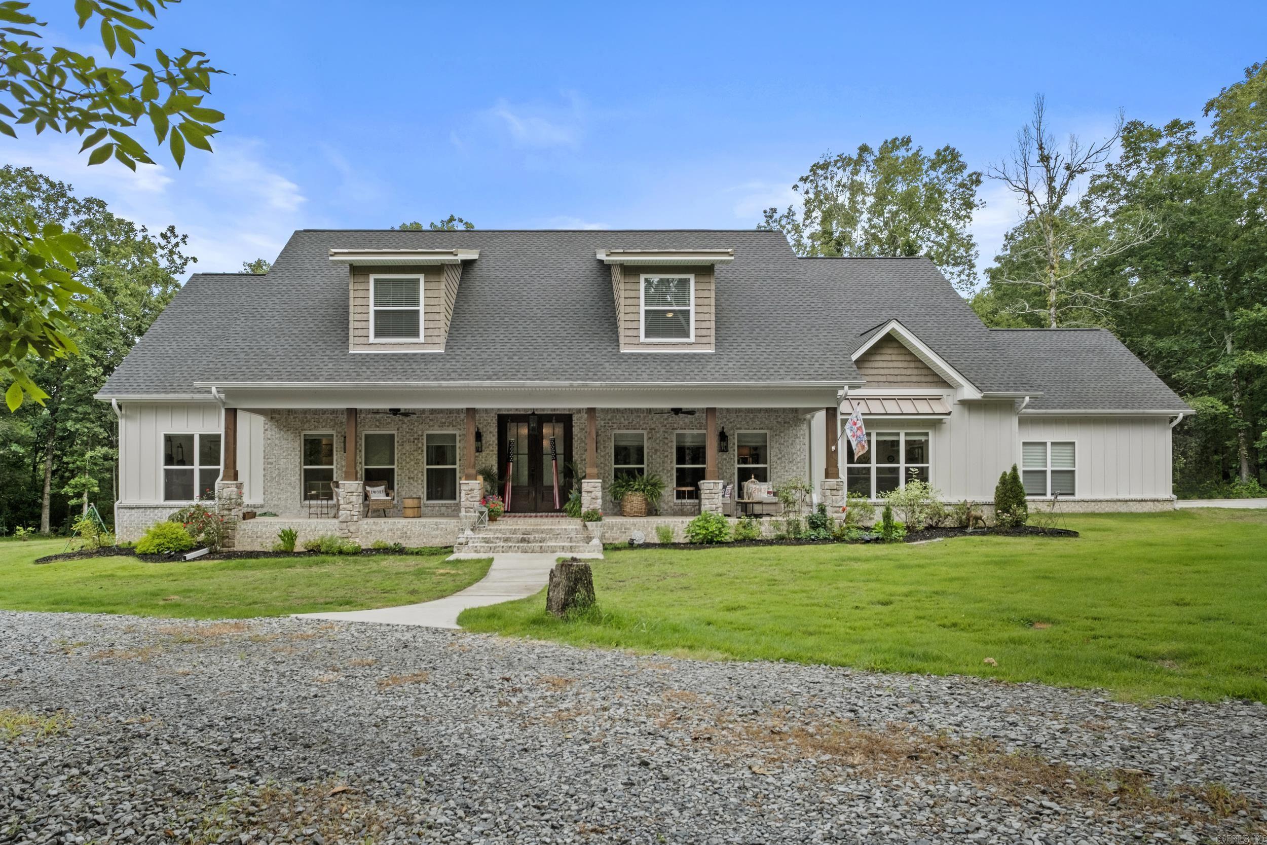 Luxury, privacy, and exceptional craftsmanship define this stunning custom-built estate nestled on 24 picturesque acres just five minutes from Searcy. Completed in 2024, this thoughtfully designed home offers just under 4,130 square feet with 6 bedrooms, 4.5 baths, a bonus room, and abundant storage throughout. The chef's kitchen is a true showpiece with an oversized island, gas range, pot filler, and two butler's pantries leading to an exceptional laundry room with a built-in ice maker, farmhouse sink, folding station, desk, and private access to the fenced dog yard. Spacious living areas, anchored by double-sided fireplaces, are filled with natural light and designed for effortless entertaining. The vaulted covered back porch features a beautiful wood ceiling and outdoor fireplace, creating the perfect place to unwind. The property also includes a private pond, creek, and 24 beautiful acres. A heated and cooled detached garage with a private apartment and two covered porches is ideal for guests, extended family, or a home office.