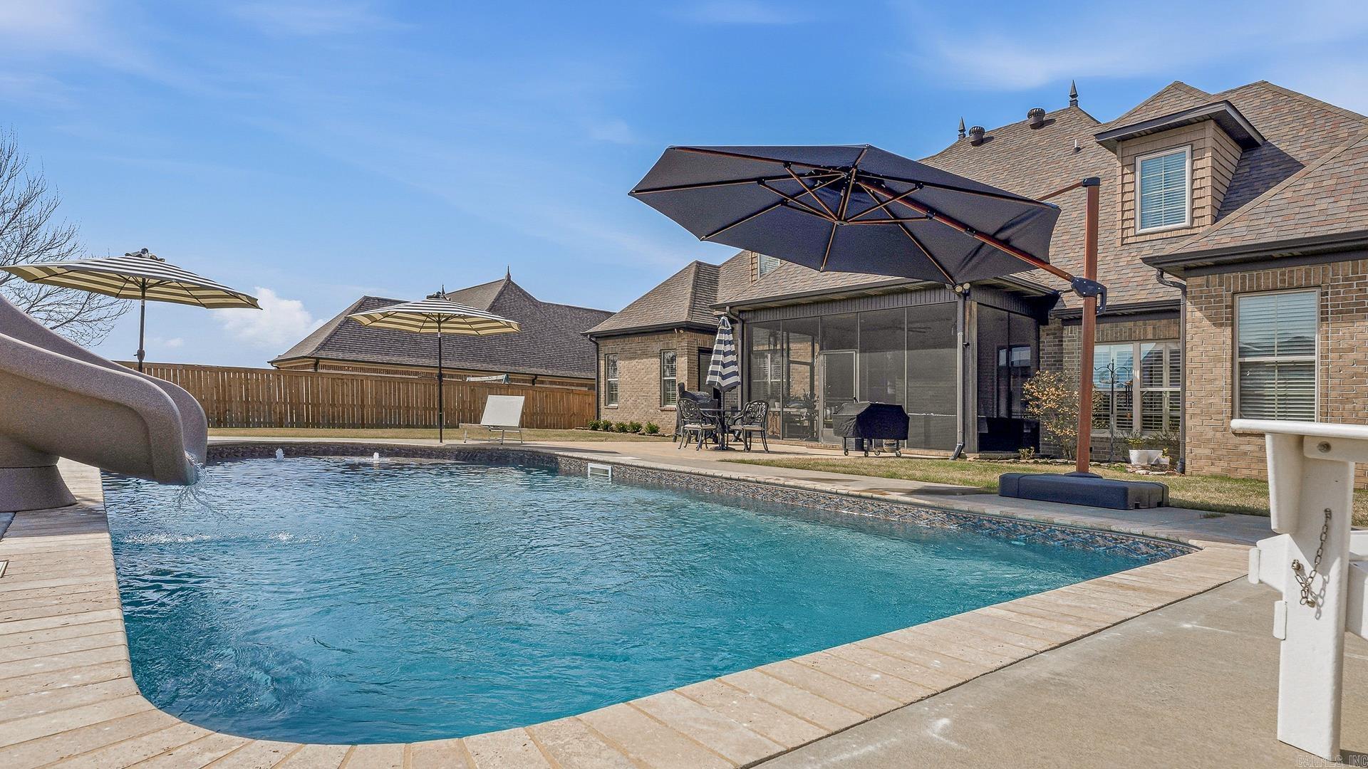 Primary on main, 3 car garage and check out the luxurious travertine lined heated/chilled pool at 4309 Weldon Lane! Pool features include a slide, lights, bubblers, pool deck, umbrella holders, and a new liner. The sizable screened-in back porch upgrades this back yard living to the next level too. The two story stone and brick exterior is beautifully designed and accented with extensive landscaping front and back. Inside you'll find hardwood floors in the main living areas, herringbone patterned stone in the kitchen, granite throughout, and ceramic tile in the baths. The property boasts a dining room, butler's pantry, stone fire place, generous office, breakfast bar, surround sound, 4 beds, 3.5 baths, walk-in closets, oversized bonus room, & two attics. The 21 foot ceiling and arched balcony opens up the living area creating a spacious feel to the home. Key updates to the home include new kitchen back splash & stone floors, a new driveway, new paint (color drenched), custom wall paper, new lighting, custom window treatments, window tinting, & plantation blinds. The primary en suite has a with a soaker tub, walk-in shower & closet