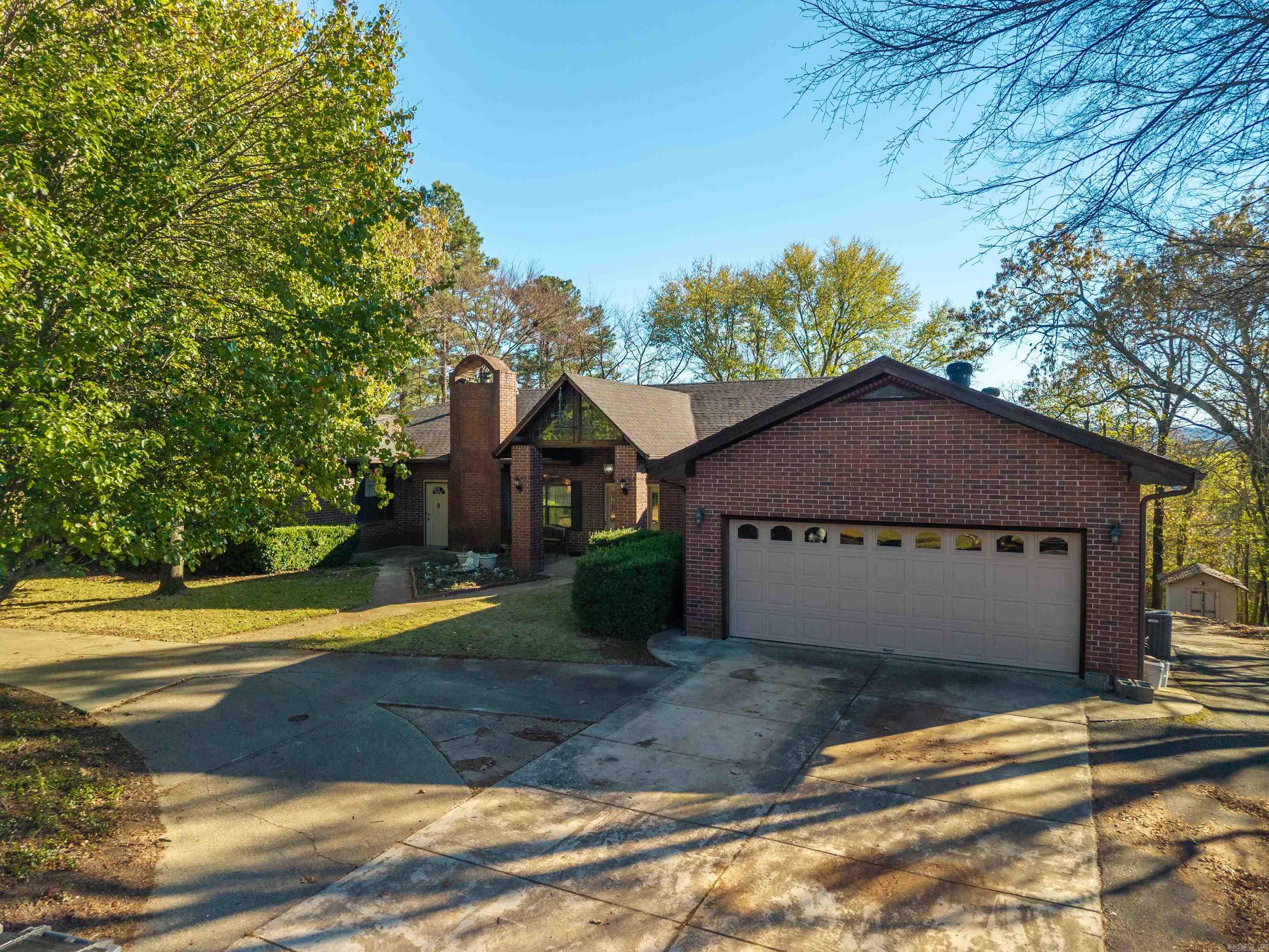 This 7 Bedroom 5 Bath home is perfect for a large family or multi-generational living.  Located just minutes from Oaklawn in a quiet neighborhood close to everything Hot Springs has to offer!  The main level features the primary bedroom and ensuite bath and a guest bedroom and a full bath, kitchen, separate dining room, a large family room with one of 3 gas fireplaces, as well as an office and laundry room.  there is a large deck overlooking the private back yard with partial lake views.  the lower level has 3 bedrooms, 2 full baths an office, dining family room combo and a kitchen with a large island.  This level has a laundry room with a gas or electric dryer hook up. There is access to a patio and the back yard om the lower level. The separate entry mother-in-law suite has 2 bedrooms, one bath and a kitchen, dining, living combo. There is access to the back deck as well.  There are two 40-gallon gas water heaters and 3 HVAC units.   Arzella Acres is a private subdivision with secured entry and lake access.  POA dues are $50.00 a year.  Call me to see this very special home today!