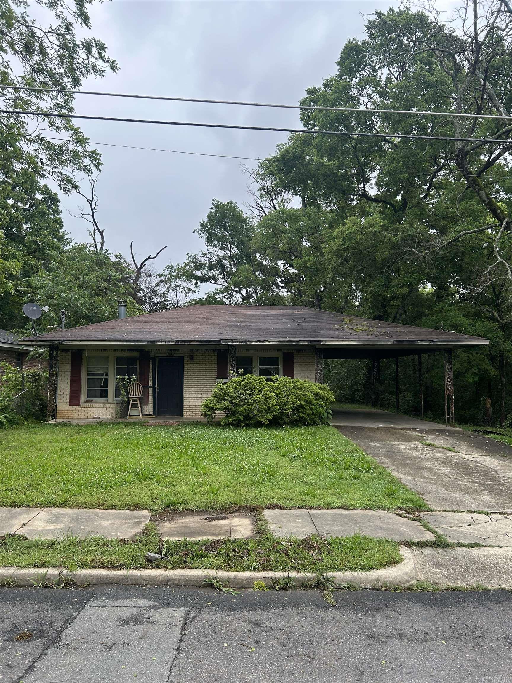 Welcome to this 3-bedroom, 1.5-bath brick home offering 1,261 square feet, a carport, and just enough fire damage to make things interesting. This half-baked beauty has been tastefully pre-distressed, saving you years of wear and tear. Thankfully, the exterior remains intact, as well as portions of the interior.  Inside, you’ll find a functional floor plan, solid bones, and renovation potential throughout. Select areas feature an “open ceiling concept,” while some rustic charred accents add a level of character you simply can’t recreate with modern design trends.  With damage limited to only part of the home, this property offers a rare chance to restore, rebuild, and build equity all at once. Whether you’re an investor, flipper, or ambitious homeowner, this could be your opportunity to own the house everyone on the block will remember.  Being sold AS-IS.