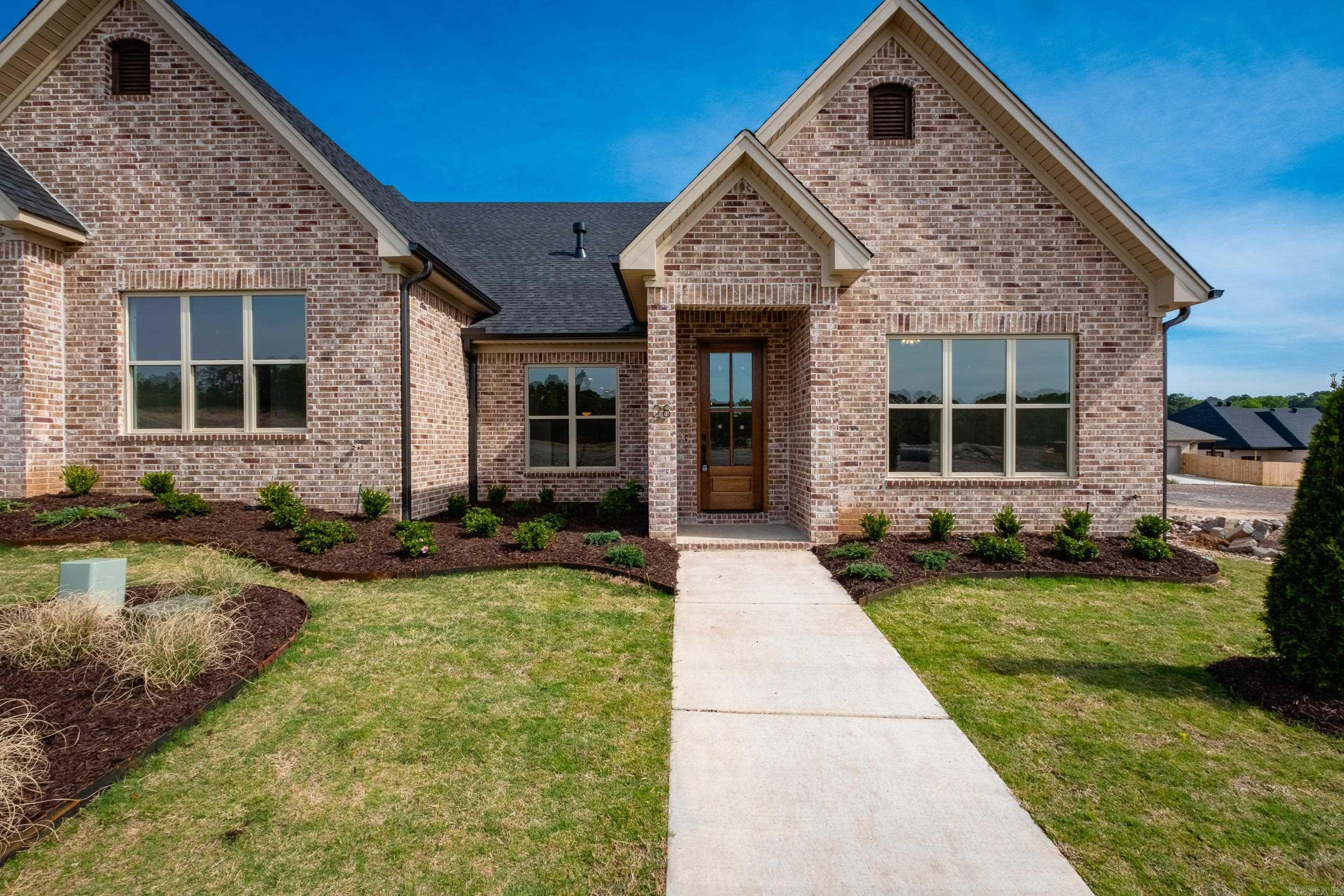 Welcome to Edgewood, West Little Rock’s newest neighborhood where upscale living meets low-maintenance convenience. Built by Graham Smith Construction, this thoughtfully designed 3-bedroom, 2-bath attached home offers modern comfort with no yard work required—lawn care is included. Step inside to a bright, open-concept layout with designer finishes at every turn. The living area features a cozy fireplace and flows seamlessly into a sleek kitchen outfitted with quartz countertops, custom cabinetry, stainless steel appliances, and a stylish tile backsplash. Luxury vinyl plank flooring runs throughout the home, adding warmth and durability. The primary suite is a calming retreat with a spacious walk-in closet, a large vanity, and a tiled shower. Enjoy outdoor living on your private, covered patio, perfect for morning coffee or evening unwinding. A 2-car garage adds parking and additional storage. Located just 3 minutes from Costco! Edgewood offers easy access to all that Little Rock has have to offer. With early-phase availability, now’s the time to invest in this beautiful new community. Set for completion March 2026. Renderings and photos are from similar completed homes.