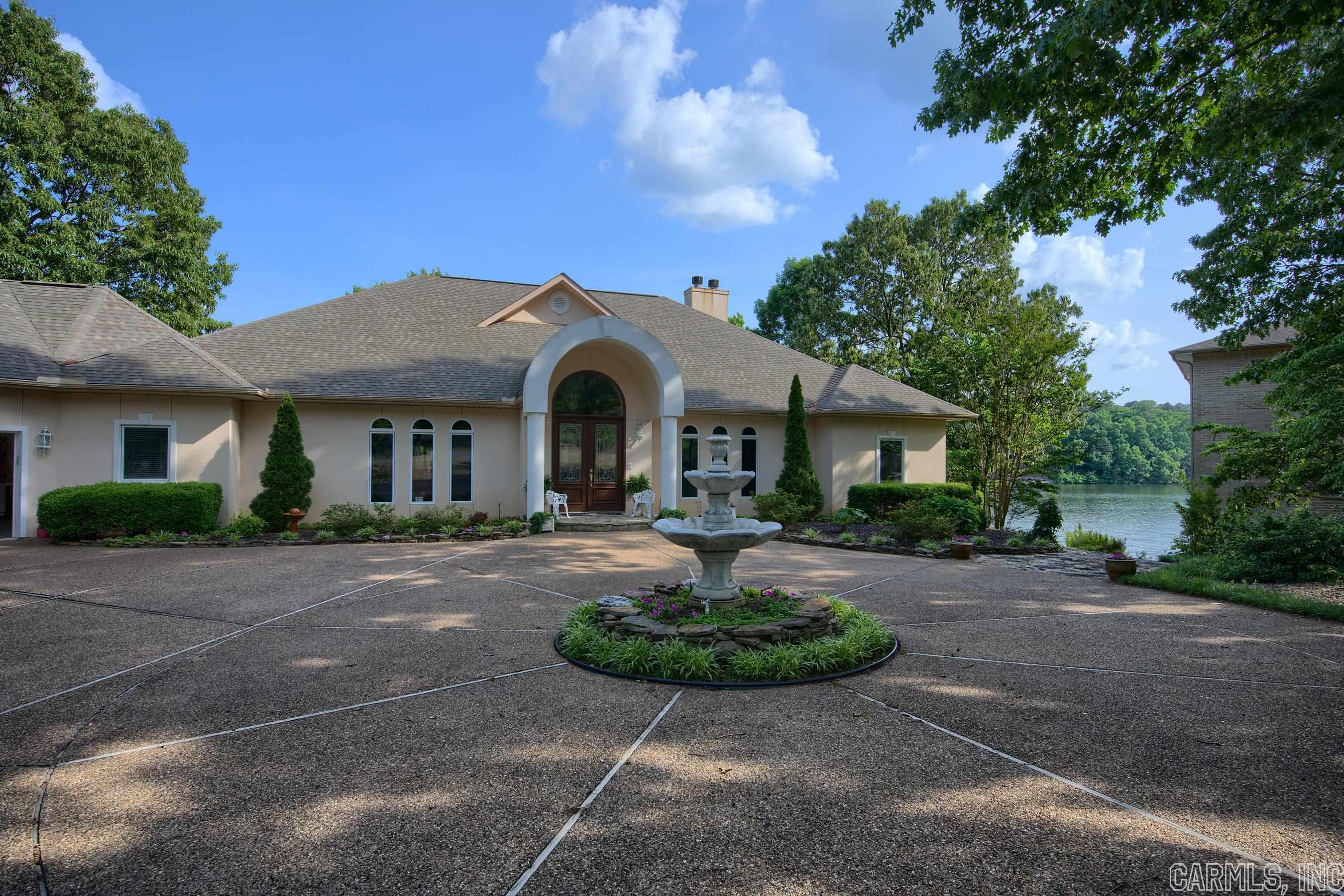 It's hard to describe "Perfect" and this home is perfect in every way! Approx. 6196 h/c sq ft with every ft usable space. 5 Bedrooms , 4 1/2 Baths, Great Room, Arkansas Room, Office, Open Kitchen, Formal Dining, Breakfast Area, Private Primary Bedroom and large Primary Bath, Laundry Room, 3 Car Plus Garage, Gas Fireplace - Lower Level offers 2 Bedrooms ,2 full baths, Cedar Closet, Lots of H/C Storage Areas, Exercise Room/Extra Bdrm, Theater Room with Surround Sound- H/C Workshop, Family Room.  Wood burning Fireplace - Covered Boat Dock with lift, Swim Dock, Stone Walkways, 2 Water Features, Lower level Patio, approx. 233' of lake frontage with a beautiful South Eastern Exposure. Stucco exterior, large covered porch, lake sprinkler system park like landscaping with bountiful perennial flowers and stone walkways. Check out the virtual tour, lot plat and features listed. BRAND NEW GEO THERMAL UNIT IN WITH AN EST. ELECTRICAL AVERAGE OF $222 MONTHLY!!