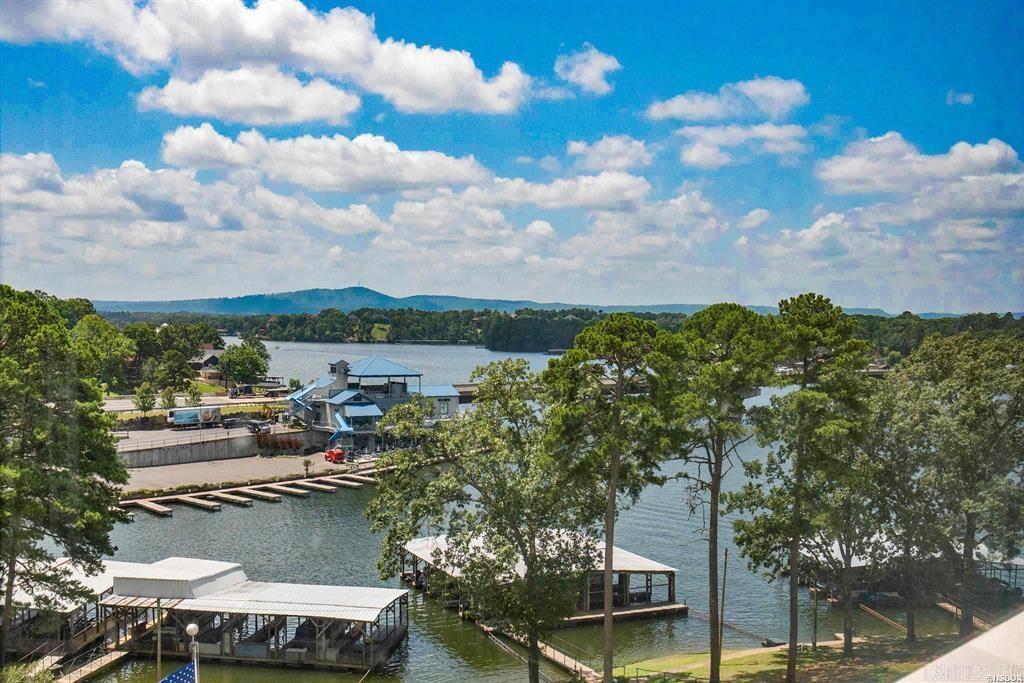 Affordable and spacious one bedroom lake retreat in one of Lake Hamilton's most desirable locations.  This one has it all:  *Great View *Covered Parking * Boat Slip  *Upgraded Kitchen with Granite & Buffet Storage *Gated Entry *Prime Close-to-Everything Location on Lake Hamilton *Large Walk in Closet *Balcony Sunroom  *Delightful Covered Common Patio Overlooking Pool and Main Channel *Fully Furnished *Beautiful Grounds *Lovely Pool *Elevators for Easy Access *Tennis/Pickleball Court *Recreation Room *Laundry Room *TV Room * Area for Boat Trailer Parking *Water and Trash Service Included (with no extra charge).  The location is just minutes from Oaklawn and downtown Hot Springs making Lake Hamilton living easy and convenient.  And nightly rentals are allowed for potential extra income. Much to like here!