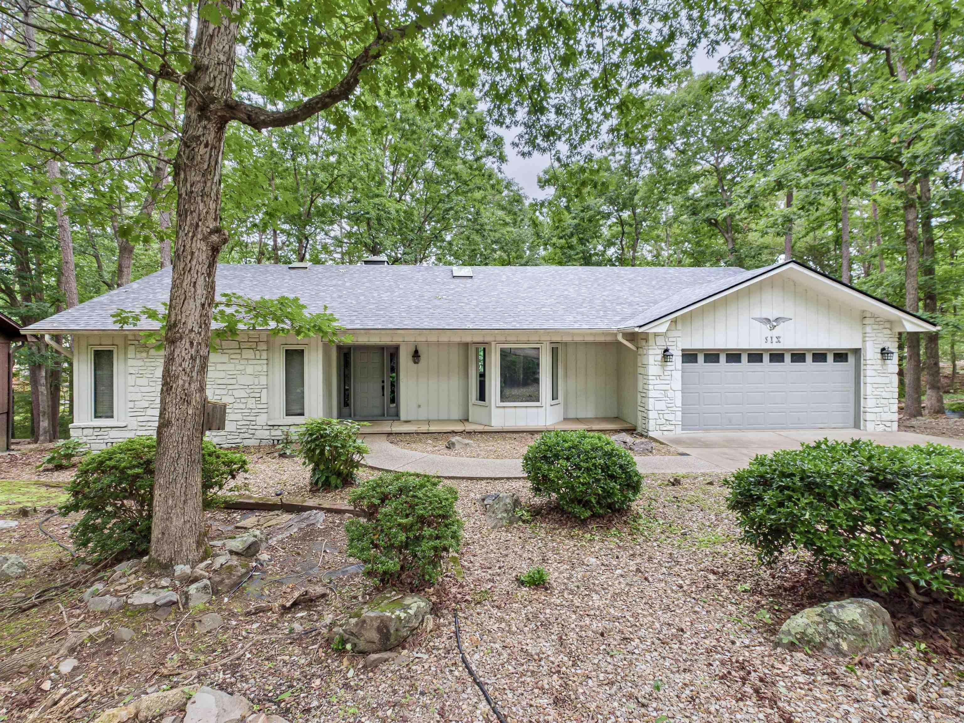 Lakeside retreat in HSV! This 3-bedroom, 3-bathroom home offers spacious living with access to Lake De Soto. Beautiful kitchen with granite counter tops and stainless appliances overlooking the expansive living room with a beautiful view!  NEW Roof 2024, NEW skylights 2024. Many updates throughout! Wonderful lower level with it's own kitchen makes this home abundant with options for your family's needs.  Expansive deck, ideal for hosting gatherings and soaking in the serenity of your surroundings. Privacy at it's finest.  The best part of this property is the access to Lake De Soto.. it's right in your backyard! Imagine spending your days fishing, boating, or simply basking in the beauty of this pristine lake.