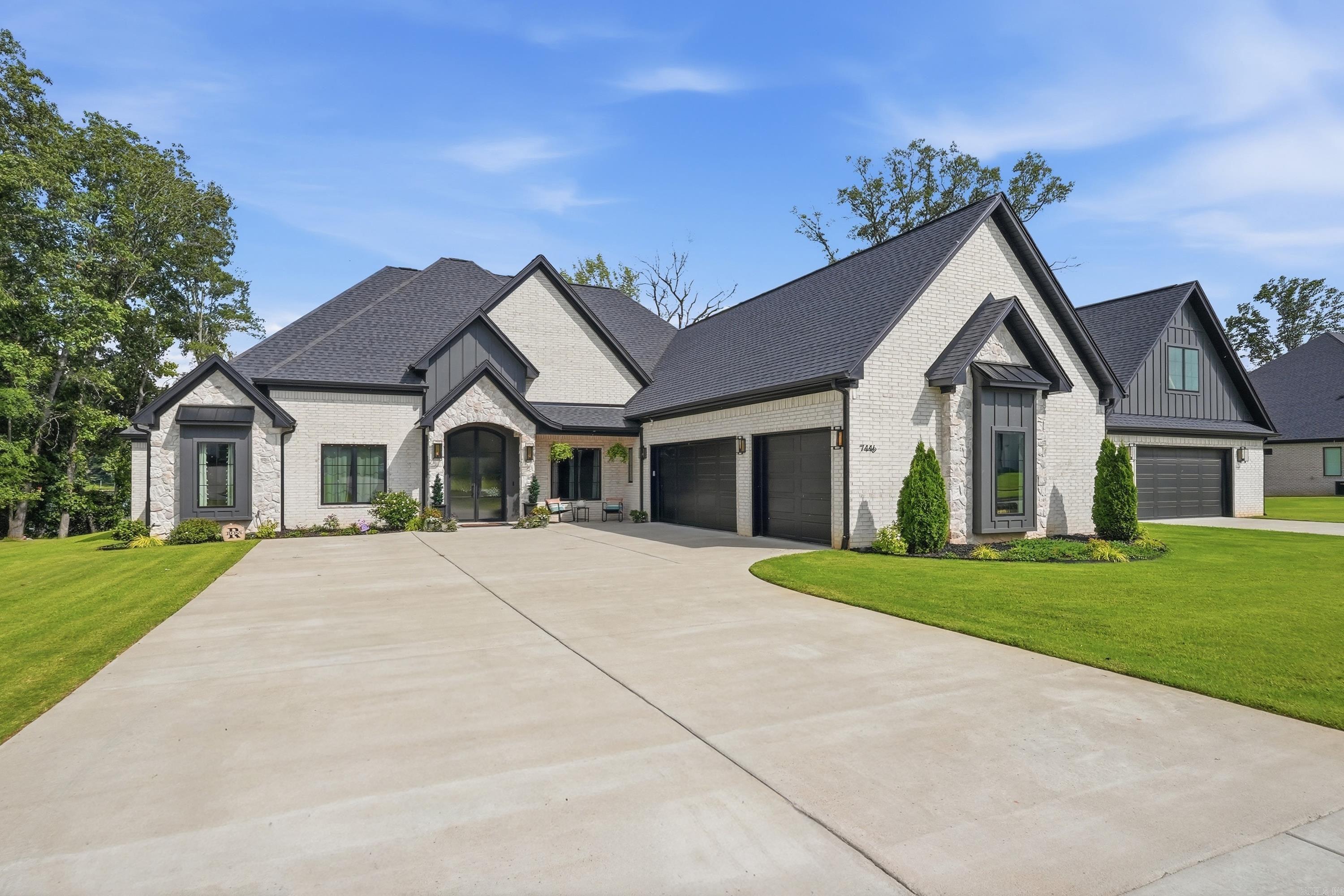 Luxury lake living awaits inside the gated Pointe at Hurricane Lake Estates. Make a grand first impression through double 12-foot arched iron doors that open into an expansive foyer, setting the tone for the exceptional design throughout this 4-bedroom, 4.5-bath home. Hardwood flooring flows throughout, complemented by a dedicated office with closet, spacious bonus room, and thoughtfully designed spaces for everyday living and entertaining. Even the laundry room was designed with convenience in mind, featuring a built-in indoor dog kennel and dog wash. Step outside to an oversized screened-in patio, outdoor kitchen, and stunning 20x40 pool with expansive sun ledge. Enjoy direct water access from your private dock/boat slip, plus an in-ground trampoline & fenced pet area with doggy-door access to the garage. A two-story 30x40 shop provides space for storage, hobbies, and lake equipment. Additional features include a Generac whole-home generator and comprehensive security system. With access to neighborhood amenities and a rare combination of luxury, recreation, and waterfront living, this home offers an exceptional lifestyle in one of Saline County’s most sought-after communities.