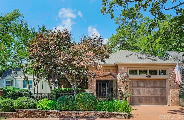 New Orleans style patio home just blocks from CCLR.  This one level home has full house generator & a one car garage that is covered into the home. Formal spaces great you as you enter the front door.  The formal living room has a beautiful fireplace & the windows are aligned with planation shutters, also beautiful hardwoods throughout most the house. The primary bedroom is in the back overlooking and opening up to the fenced backyard, fully landscaped. Enjoy relaxing under the pergola or on the covered porch with heaters.  Primary bath features a large window overlooking the private garden with both a whirlpool tub & a large shower, vanities, and nice sized walk in closet.  Beautiful quaint kitchen with wonderful appliances open to the hearth room with fireplace.  The kitchen is sunny & bright!  Nice sized laundry is easily accessible from kitchen & has extra storage. Two other bedrooms & two baths make up the rest of the home. Currently one of the bedrooms is used as a breakfast room & has outstanding storage for china & crystal & other entertaining items. This elegant home is the perfect answer to downsizing while still having a beautiful home for entertaining family & friends!