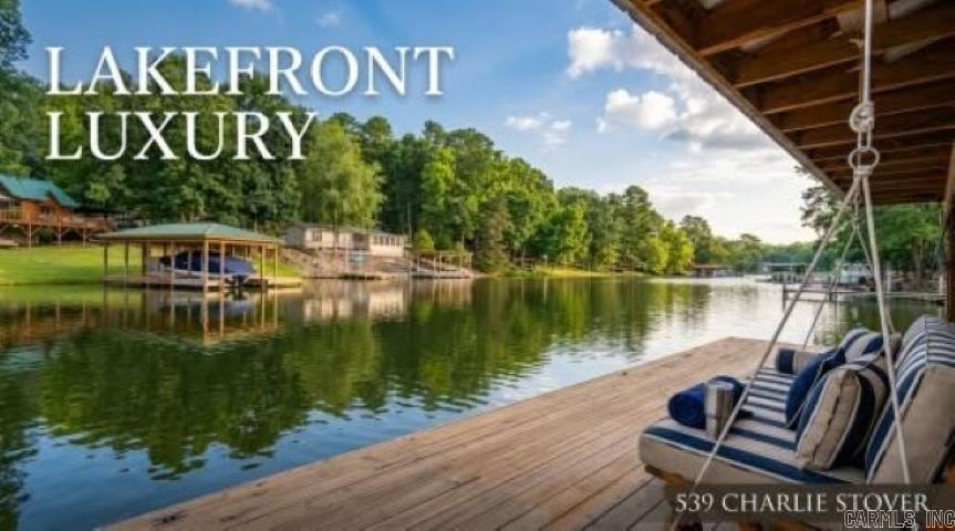 Welcome to the lake life you've been dreaming about! This spacious all brick home was built for entertaining, relaxing, and making memories. With a RARE private boat ramp (these are not common), boat dock, a gorgeous lakefront lot, you'll spend less time loading up & more time enjoying Lake Hamilton-tubing, island adventures & restaurants & more! The expansive back deck offers breathtaking lake views. Over 100 ft lake frontage! perfect spot for sunset gatherings  Whether you're hosting family reunions, holiday celebrations, or weekend lake parties, there's room for everyone here!  The lower level is a standout feature, offering a huge living area, large bedroom, full bathroom, and its own private exterior entrance—making it ideal for guests, extended family, a mother-in-law suite, or even additional rental potential.  Located in the county, this property offers the flexibility many buyers are looking for, including the possibility of short-term rentals. Rare lake amenities, incredible views, privacy, wildlife, and plenty of space to spread out—this is more than a home; it's a waterfront lifestyle waiting to be enjoyed. Don't let this one sail away!