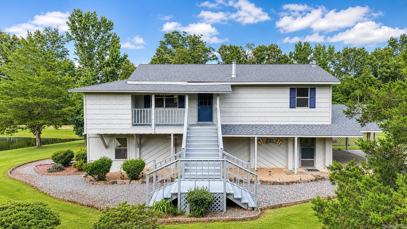 Nestled on over 4.35 peaceful acres, this unique property offers endless possibilities with more than 2,300 square feet of living space, 3 bedrooms, and 2.5 bathrooms. The flexible floor plan is ideal for multigenerational living, guests, or added privacy, featuring a bedroom, living room, kitchen, laundry area, and bath on the main level, while the upstairs includes a second kitchen, spacious living room, two additional bedrooms, and a full bath. Outside, you'll find a large shop with electricity that previously operated as a hair salon, offering incredible potential for a home business, hobby space, workshop, or studio. The shop also includes abundant storage and workspace on the opposite side. Additional outdoor features include a pond, covered storage, and covered parking, all set in a quiet rural setting that provides space and tranquility. Located in a USDA Rural Development eligible area, qualified buyers may have the opportunity to purchase with potential 100% financing ($0 down). Don't miss your chance to own this versatile property with room to live, work, and enjoy country living.
