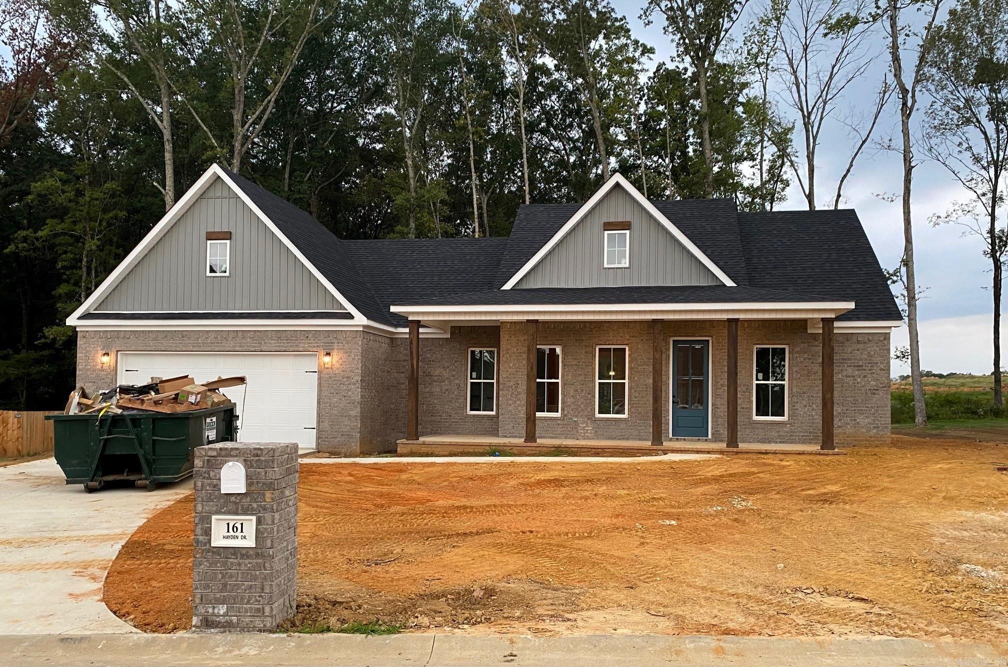 Beautiful new construction in Beebe!  This lovely brick home has large cypress columns and covered porches front and back! An airy open floor plan includes a chef's kitchen and pantry. Utilize the flexible area for formal dining, office or home school with high-speed fiber optic available! Primary bedroom has walk through laundry to large walk-in closet, his/her vanities, custom tile shower and garden tub.  Tall windows and door open to a huge, covered patio and an outdoor grill area convenient for entertaining. Energy efficient and new!