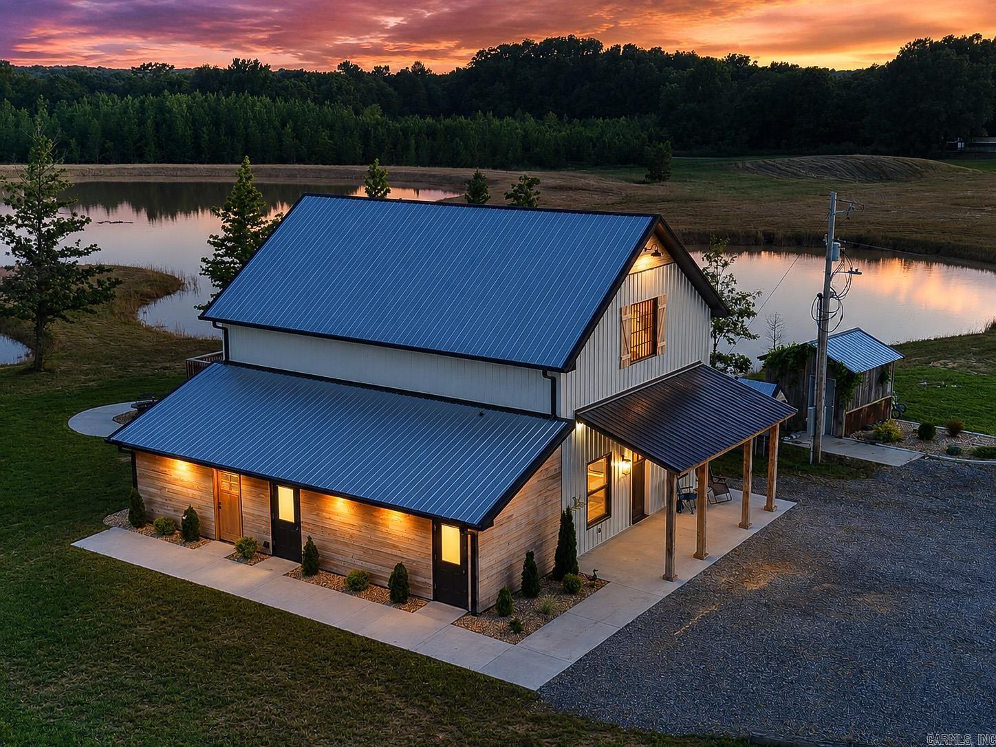 Hunter's Paradise Lodge! This fully furnished 2,000-square-foot home is a sportsman's dream, offering incredible hunting, fishing, and income-producing potential. A scenic bayou runs through the property, providing outstanding duck hunting opportunities, while the beautiful 8-acre pond, approximately 14 feet deep, is perfect for fishing and recreation.  Inside, you'll find custom countertops imported from Brazil, all-new appliances, a completely updated bar with new equipment, and a new 80-gallon hybrid water heater. The lodge also features a Culligan water system, eliminating the cost of a water bill. Included are approximately $65,000 worth of professionally mounted trophies, creating the ultimate hunting lodge atmosphere.  The property includes 12 RV sites for additional income, along with a separate shower facility and dedicated laundry area for guests. Whether you're looking for a private retreat, hunting camp, or investment opportunity, this turnkey property offers the perfect combination of comfort, recreation, and revenue potential. Move in and start enjoying everything it has to offer from day one.