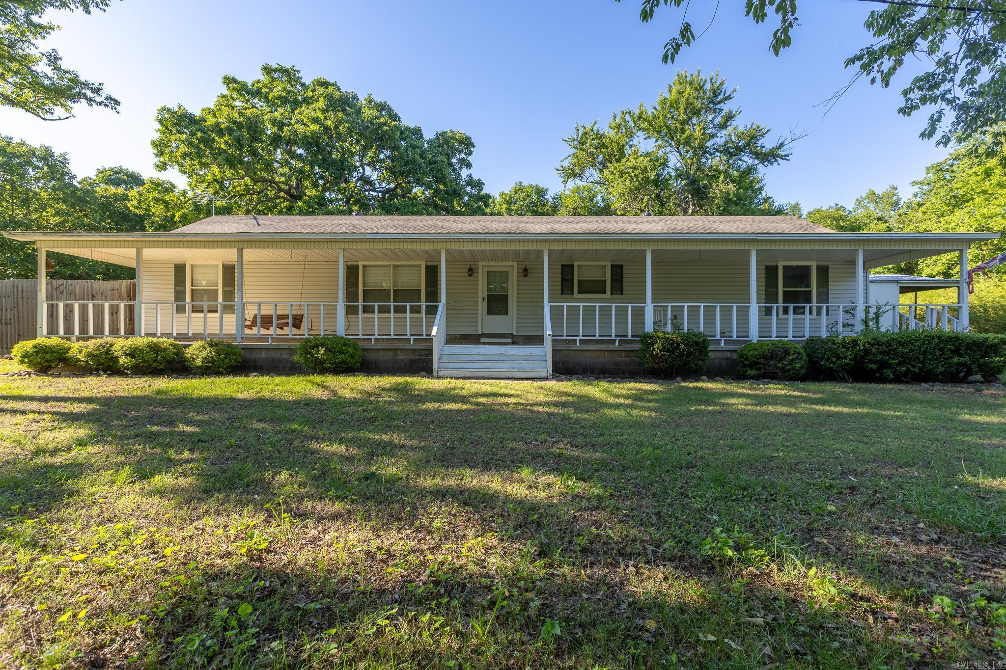 Experience the best of country living at 14 Hilltop Lane in Vilonia! This well-maintained 3-bedroom, 2-bath home sits on approximately 1.3 acres, offering plenty of space to enjoy the outdoors. The property is packed with features, including a detached shop, covered RV parking, and a large storage shed—perfect for storing tools, outdoor equipment, recreational vehicles, and all your toys. Whether you're a hobbyist, need extra workspace, or simply appreciate room to spread out, this property delivers. The spacious yard provides endless opportunities for gardening, entertaining, or relaxing in a peaceful setting. Combining comfort, functionality, and versatility, this property is ready to welcome its next owner. Schedule your private showing today!