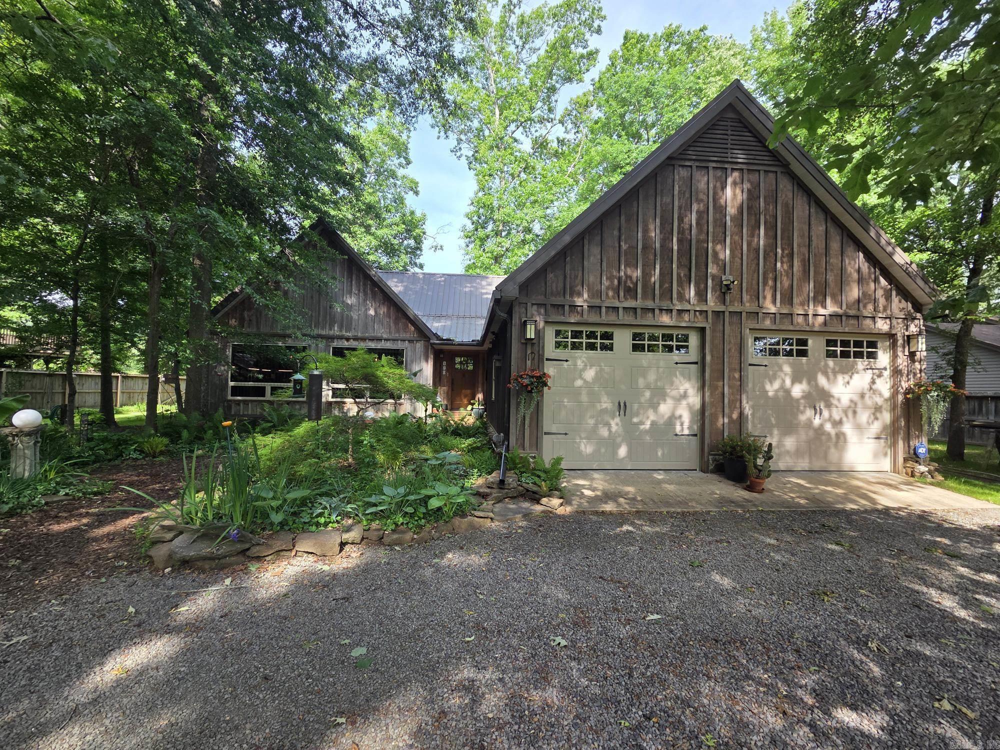 Trout fishers dream house with 3 full baths, 10x30 sunroom, loft that can be used as a 3rd bed or bunk room, 14x28 shop with overhead door & heat & air and covered boat dock with lift. This beautifully landscaped riverfront house has French drains, gutters, wood floors, wood walls & wood ceilings in most areas. Natural rock wood fireplace towering up to the vaulted ceiling & surrounded by large glass windows. Custom kitchen is equipped with cafe' brand matt black gas stove, dishwasher, microwave & refrigerator. It has a copper farmhouse sink, quartz countertops, custom oak cabinets, backsplash, island & pantry. Large Pella windows throughout house provides abundant natural light. French doors at both ends of sunroom & several in primary bedroom. Relax around the shaded natural rock fireplace area & enjoy the firepit & peaceful sounds of the river & birds. See agent remarks!