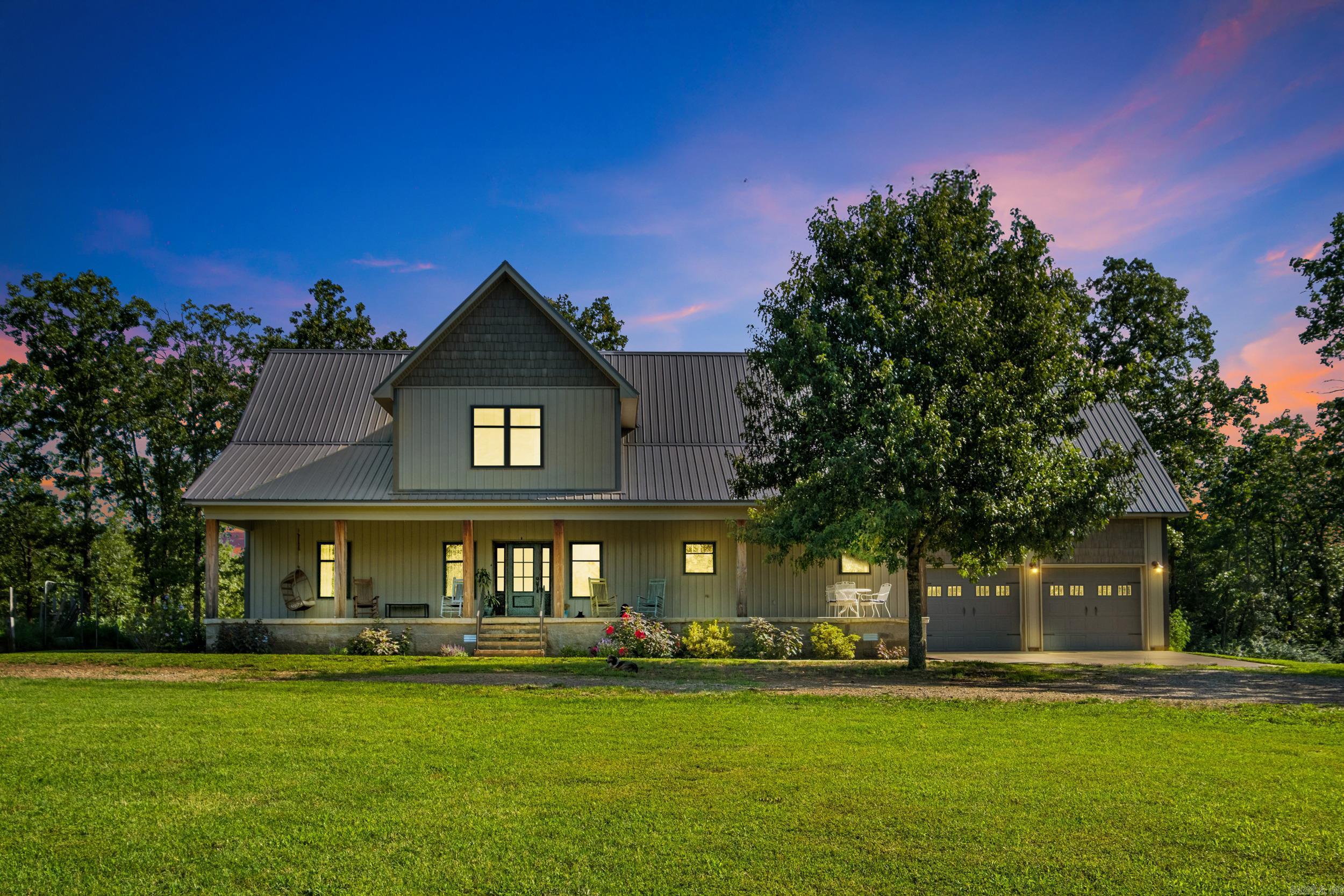 Welcome to your own private retreat! This custom-built, 4BR, 3.5BA home sits on 8 peaceful acres and offers 3,704 sq ft of thoughtfully designed living space. Features include an office with built-ins, two spacious living areas, abundant storage, a large laundry/mudroom, and an oversized garage with a safe room. The main-level primary suite offers access to a private covered deck and a spa-style bathroom with a freestanding tub, tiled walk-in shower, custom cabinetry, and a large built-in closet. Upstairs are two oversized bedrooms, each with a full bath and multiple closets, plus a central second living area and laundry chute. The open-concept kitchen/living area features vaulted ceilings, natural light, and beautiful views. Exterior highlights include a 54x60 shop (30x40 enclosed with lean-to storage and two overhead doors), a circle driveway, and large covered porches. A rare find offering space, comfort, privacy, and room to grow!  Additional 20.5 acres and a 4-acre stocked pond are available for purchase separately. Video tour and aerial photography may depict additional additional acreage and pond not included in the current 8-acre offering.